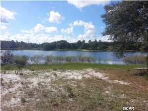 Waterfront vacant building lot with electric and well in place. This property is partially cleared. Could be used for single family, mobile home or duplex, (buyer to verify). Similar lot on the market for 100K. Hurry this one may go quickly. This is a bank foreclosure and is offered ''As-Is, Where-Is''.