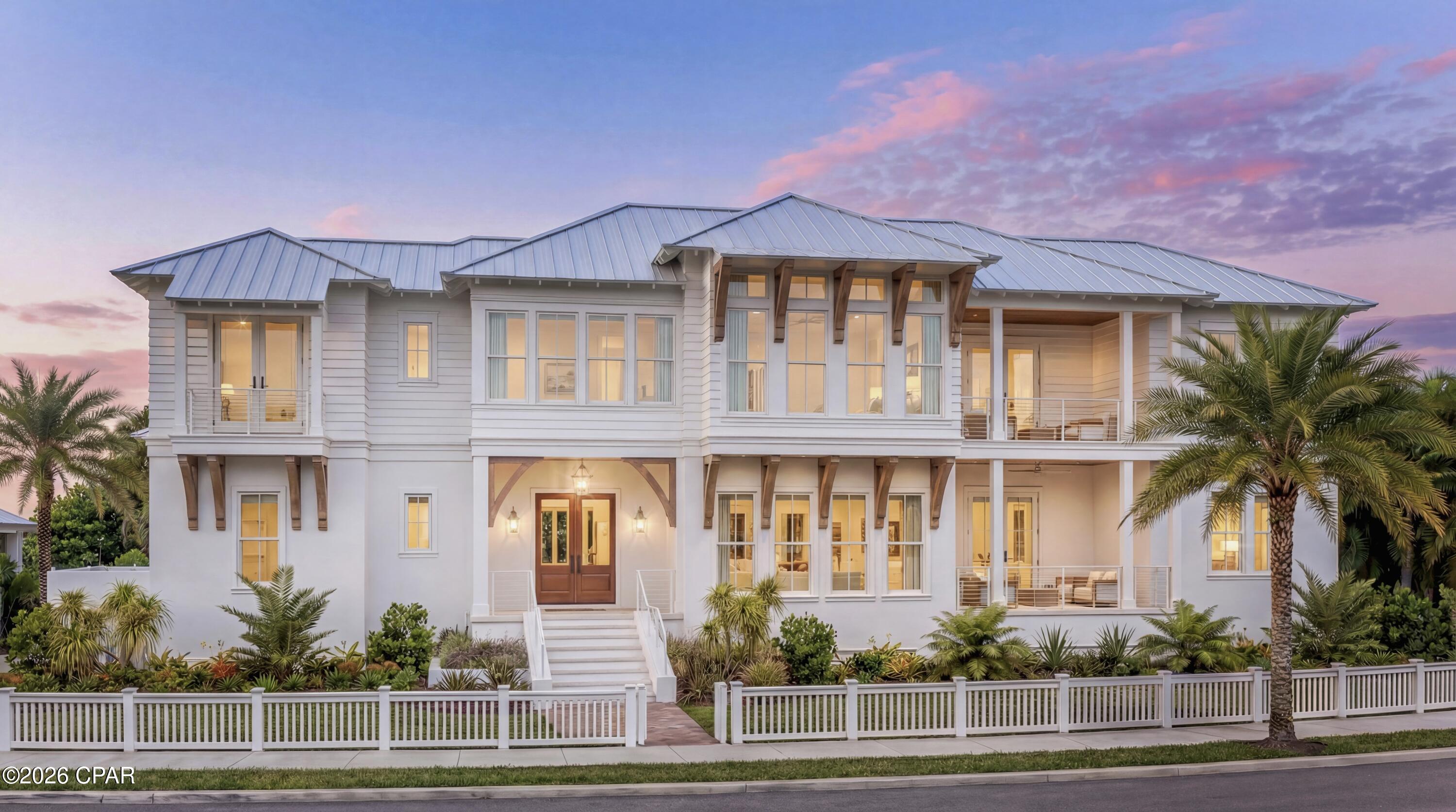 Situated on one of the largest homesites in the gated community of Carillon Beach, this exceptional pre-construction luxury custom home offers views of the Gulf and stunning views of Lake Powell, one of the world's rare and protected Coastal Dune Lakes. Designed by renowned architect J. Michael Hunnicutt and to be built by Grand Bay Construction, a respected builder known for quality craftsmanship, attention to detail, and experience in luxury coastal construction, the residence reflects timeless coastal architecture and elevated design throughout.
The home features 4,151 square feet of heated and cooled living space and is thoughtfully designed with six ensuite bedrooms, including two primary suites, along with seven full bathrooms, one of which is located in the carriage house, and a half bath serving as the pool bath, in addition to an exterior shower, providing generous accommodations for family and guests.
Interior living spaces are both spacious and versatile, featuring a well-appointed living room with lake views and a separate den or game room ideal for entertaining or relaxation. The kitchen serves as the heart of the home and is designed with a large island with seating, Wolf appliances, a 48 inch subzero refrigerator and high-end finishes with thoughtful details that balance functionality with refined coastal style. 
The residence includes an elevator shaft, a heated salt water swimming pool with an integrated jacuzzi, and a garage with dedicated spaces for a car and a golf cart, along with ample additional on-site parking for up to six vehicles, making it ideal for both everyday living and hosting guests. Two covered porches and seamless indoor-outdoor living spaces are anchored by a ventless fireplace in the living room and an outdoor fireplace overlooking the pool, creating inviting gathering areas designed for year-round enjoyment.
Located within a 24-hour private, gated community, Carillon Beach is celebrated for its pristine sugar-white sand beaches, charming town center, boutique shopping and dining, and an exceptional array of amenities. Residents enjoy multiple beach access points, several community pools including a gulf-front pool, tennis, pickleball, and basketball courts, and a golf-cart-friendly lifestyle enhanced by planned social events and activities hosted by the HOA, creating a vibrant yet relaxed coastal community. This property offers exceptional versatility as a primary residence, second home, or high-performing short-term rental with strong income potential.
This property is pre-construction. All renderings, plans, and images are conceptual, not exact, and subject to change. Finishes, dimensions, features, and specifications may vary, and the final product may differ from the renderings, plans, or models shown.