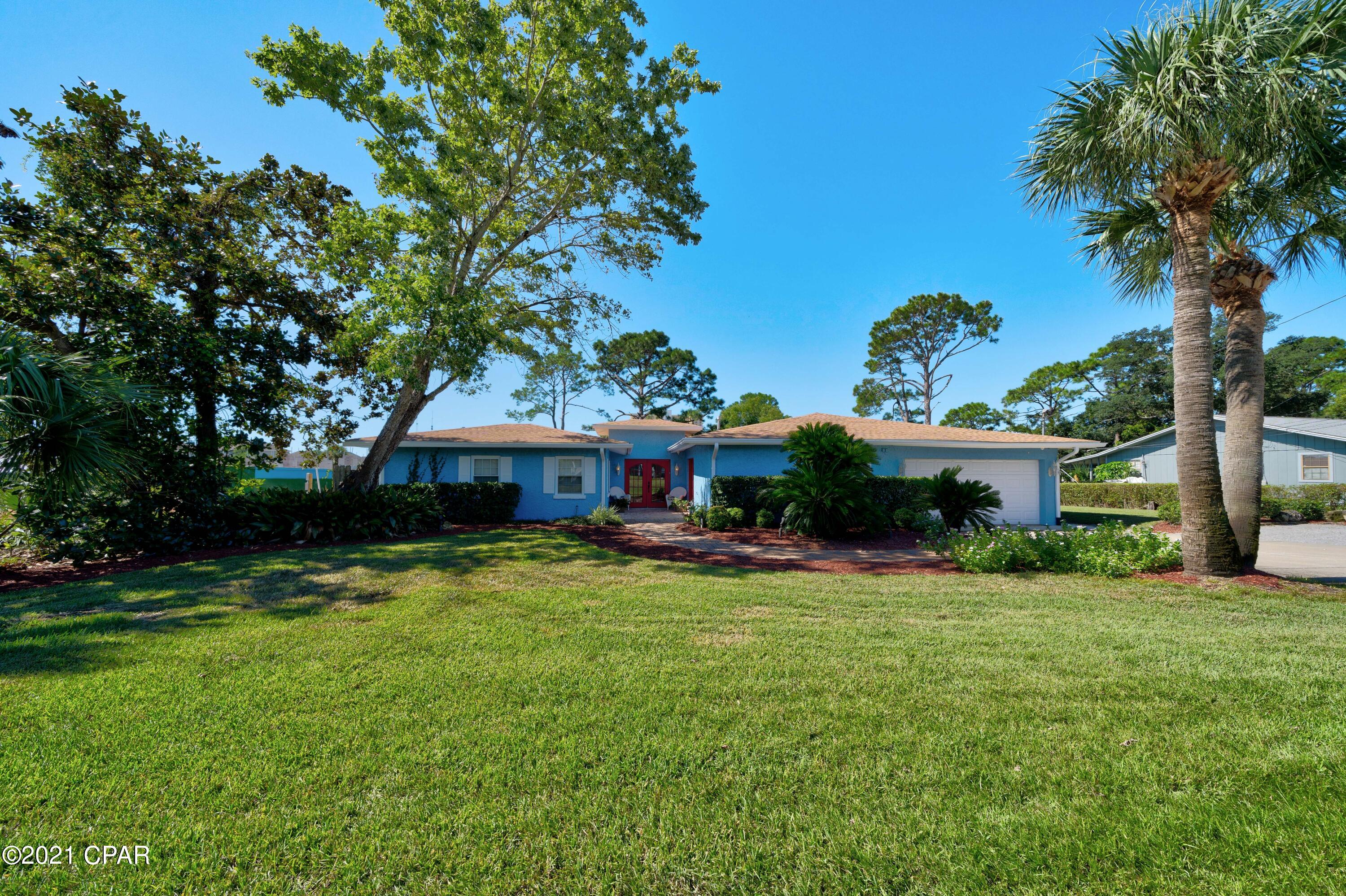 100 waterfront feet on North Lagoon in Panama City Beach! One story home on lagoon featuring 4 bedrooms, 3 full baths, gorgeous kitchen, large laundry room, office, Florida room; complete with pool, 1/2 acre yard, and dock. This well cared for home is solid with stucco over concrete block, and boasts hardwood floors, granite countertops, waterfront master that steps out to a private deck, and spacious living room with gas fireplace. Enjoy watching nature in your backyard resort with pool, patio area, green space and dock - all with lagoon views!  Backyard is fenced in, has a convenient side double gate entry, and shed with power.  2 car garage and ample driveway parking.   Private office with it's own entrance, perfect for a home business. NO HOA! Call today for your new waterfront home!