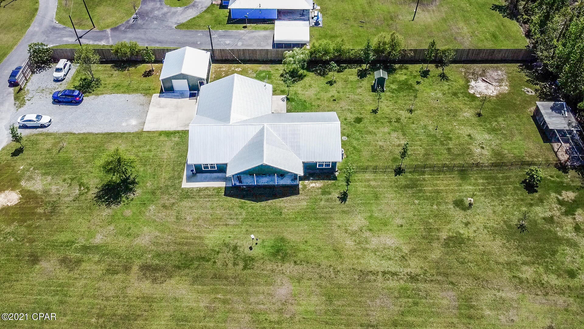 This beautiful 1.9 acre mini-farm is in pristine condition.  ALL NEW metal roof, custom kitchen cabinets, granite countertops, LVP flooring, and master bathroom with antique claw foot tub.  Split floor plan offers four bedrooms, including two master bedrooms with en suite bathrooms!  The 24x24 heated and cooled workshop has room for all your toys and tools.  Large fenced backyard has fruit trees, a chicken coop, and all the eggs you can eat,.  There's plenty of storage in the oversized 2-car garage and floored attic space.  The kitchen has a convection oven/cooktop and super quiet dishwasher but the refrigerator, washer, dryer, and freezer do not convey.  Septic and well keep expenses low.  Includes Culligan whole house water filter and weboost cell phone repeater/booster.
