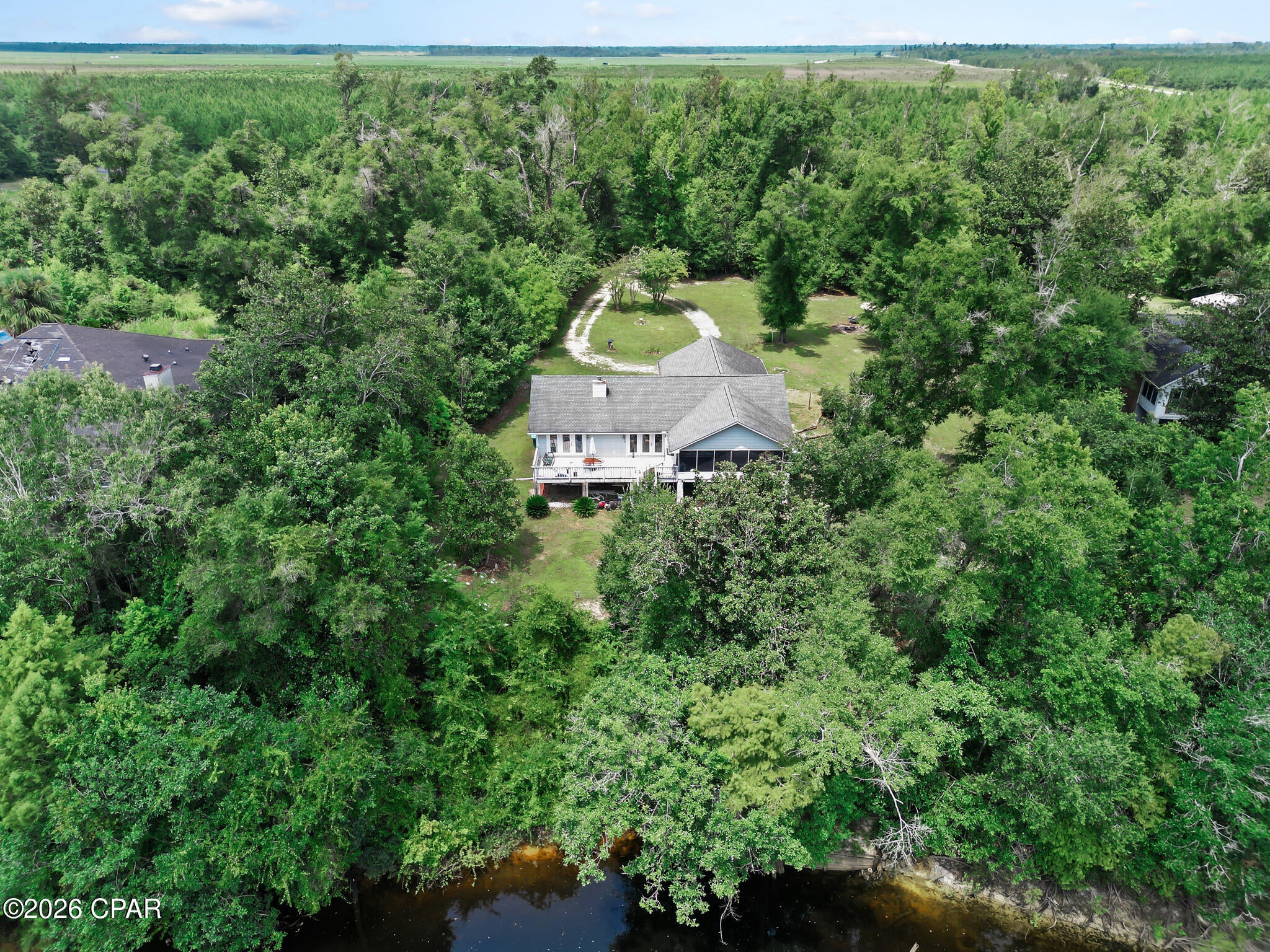 Waterfront on the beautiful Dead Lakes (Chipola River system) with direct access to some of North Florida's best fishing, boating, and outdoor recreation. Situated on 2+ peaceful acres, this property offers the privacy, serenity, and natural beauty you've been searching for.

Inside, you'll find a spacious, open-concept layout where the kitchen overlooks the large living room, making it easy to stay connected with family and guests. Expansive windows and glass doors across the back of the home fill the living space with natural light and showcase beautiful views of the beautiful river while providing easy access to the oversized back deck--an ideal place to enjoy your morning coffee, entertain friends, or simply relax and take in the peaceful scenery.

The home offers great bones and plenty of potential for someone looking to add their own personal touch. While it could benefit from some updates and TLC, a few major improvements have already been completed, including a 2019 roof and a 2024 HVAC system, giving buyers peace of mind on two of the home's biggest components.

Downstairs, you'll find a large, enclosed storage area that's perfect for a workshop or for storing tools, lawn equipment, fishing gear, kayaks, and all of your outdoor essentials. Whether you're looking for a full-time residence, a weekend retreat, or an investment opportunity, this waterfront property is full of possibilities in one of North Florida's most scenic settings.
