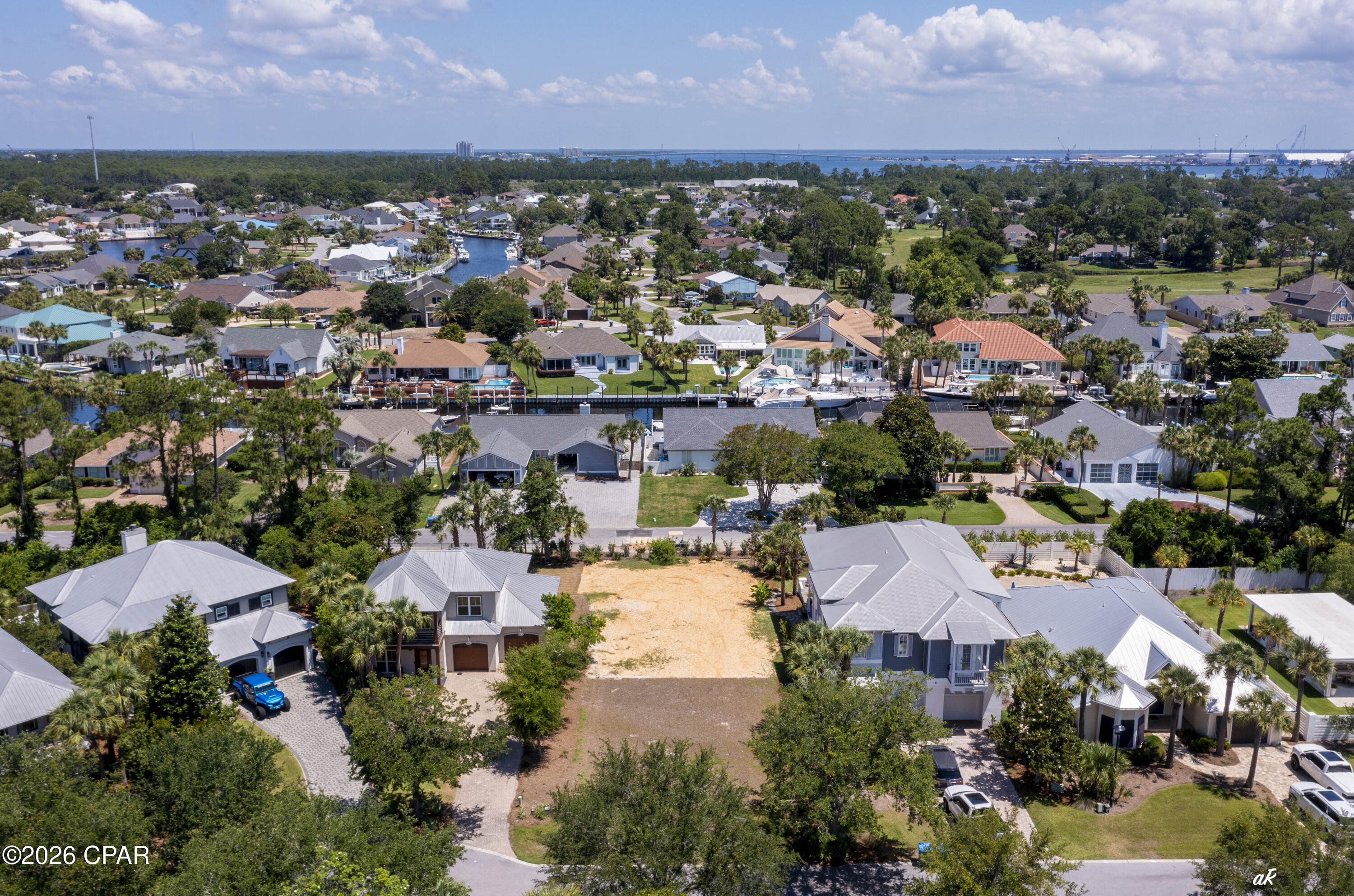 Build your dream home in Martinique, a gated community known for its natural beauty, upscale amenities, and Old Florida charm. This golf cart-friendly neighborhood offers walking trails, freshwater lakes, an island-style pool with bathrooms, a gazebo, basketball court, playground, and regular community events planned to bring neighbors together. Thoughtfully designed to blend refined architecture with nature, Martinique also offers the chance to see deer throughout the neighborhood and amenity areas. This isn't just a vacant lot, it's one of the only turnkey building sites ready for construction. The current owners have invested significant time and money to make it truly construction-ready, with the home site professionally cleared and graded, clean fill material brought-in, and drainage pipes installed at the rear of the property to maximize the backyard green space.  Utility lines are also in place and the lot is leveled for building. These improvements save you months of prep work and thousands in out-of-pocket costs, so you can break ground sooner. Located on the quiet east end of Panama City Beach, it is just a short walk or golf cart ride to Captain Anderson's, The Grand Marlin, The Dock PCB, Lighthouse Marina, and St. Andrews State Park. Don't miss this opportunity to build your custom home in one of Panama City Beach's most beautiful and sought-after neighborhoods. This one is a must see! Set up an appointment today to experience firsthand the lifestyle this picturesque property has to offer. All information is approximate and should be verified by the buyer if important.