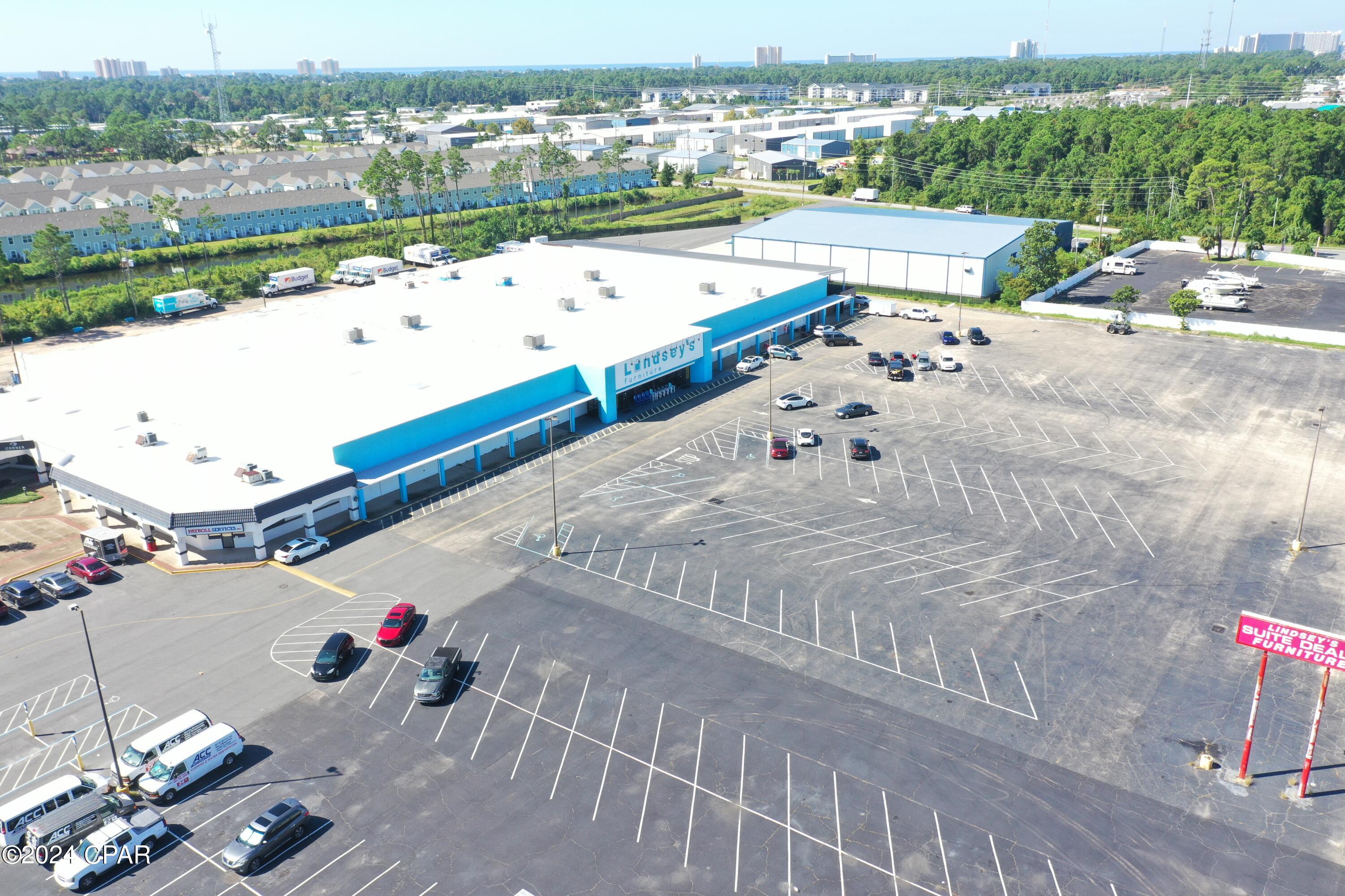 Now Leasing! Potential uses include retail, showroom, family entertainment, storage/warehouse, research & development, etc. The landlord will consider subdividing as small as 19,000 square feet for long-term credit tenants.  Previously occupied by Lindsey's Furniture, Wayne's World RV and originally built by Wal-Mart in 1985. Fantastic location. Easily accessible and tremendous exposure. The east-end of the building has been leased to 'Planet Fitness'. 19,500 to 48,290 square feet available to lease.
Sq. Ft.: 77,596 Total Heated & Cooled SF. 68,290 SF 1st Floor. 9,306 SF 2nd Floor (office, storage, and apartment),    + 6,600 Fenced Canopy
Height: 16' Eave-height 
Loading: #2, 8'W x 10'H Dock-Height
  #2, 12'W x 14'H Grade Doors
  #1, 10'W x 12'H Grade Door
Power: 3-Phase, 400 and 600 Amps
Zoning: C-3, General Commercial
  Bay County
Lease Rate:  $12.00 NNN Per Sq. Ft.