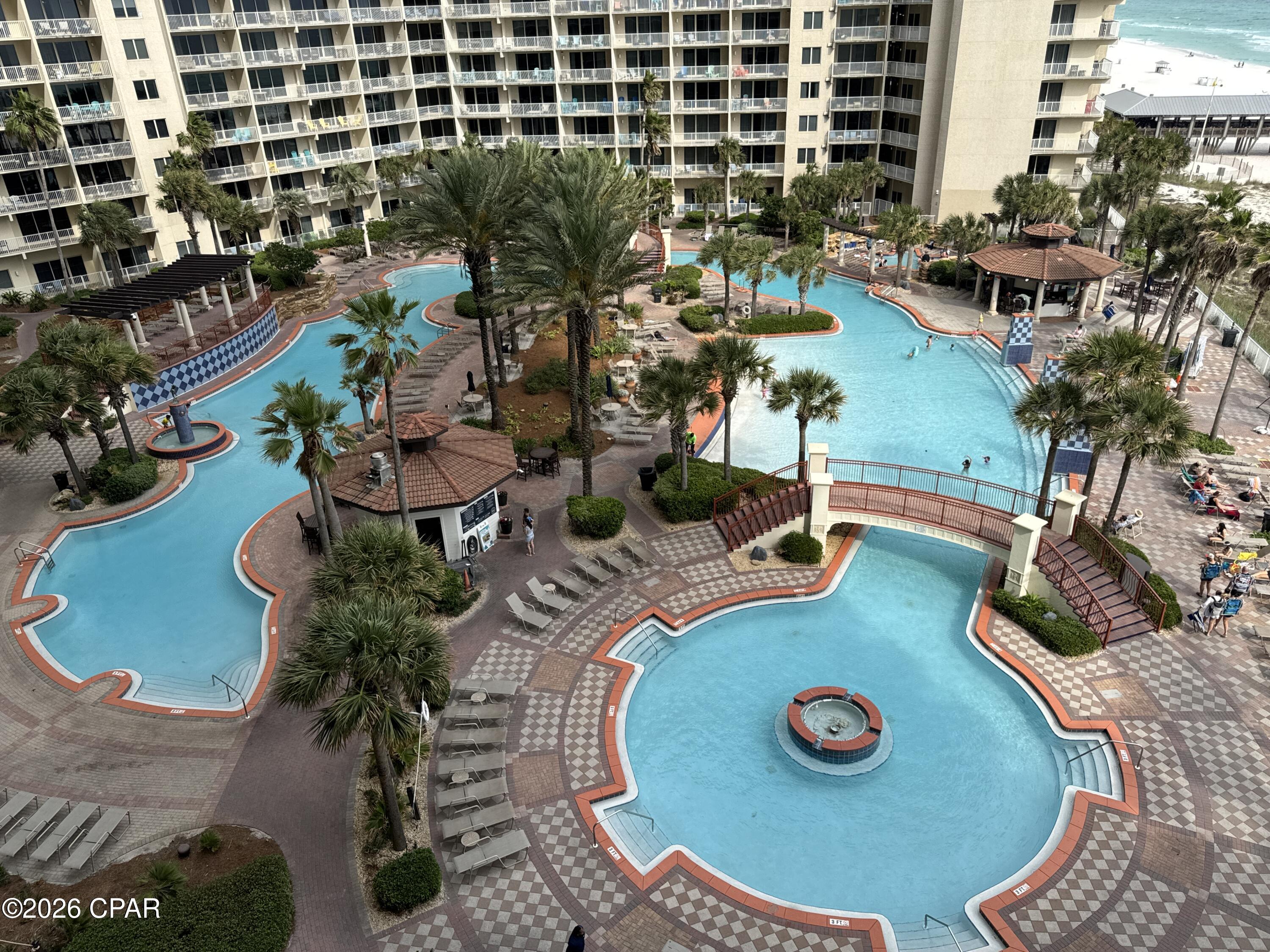 LOW FLOOR ALERT!!!  2BD Plus BUNKROOM and 3 FULL BATHROOMS.  This is the style that people love, with the 3 full bathrooms.  STRONG RENTAL HISTORY - $48,201.95 in 2024 and $54,573.46 in 2025!!   Living room and balcony have a great view of the Shores pool and the GULF OF MEXICO.  Built-in shelves and entertainment area in kitchen.  Priced to sell and low floor is very valuable in this building.  You can DRIVE UP TO 7TH FLOOR AND WALK OVER TO YOUR CONDO.   Lots of open parking on the 7th floor parking deck.