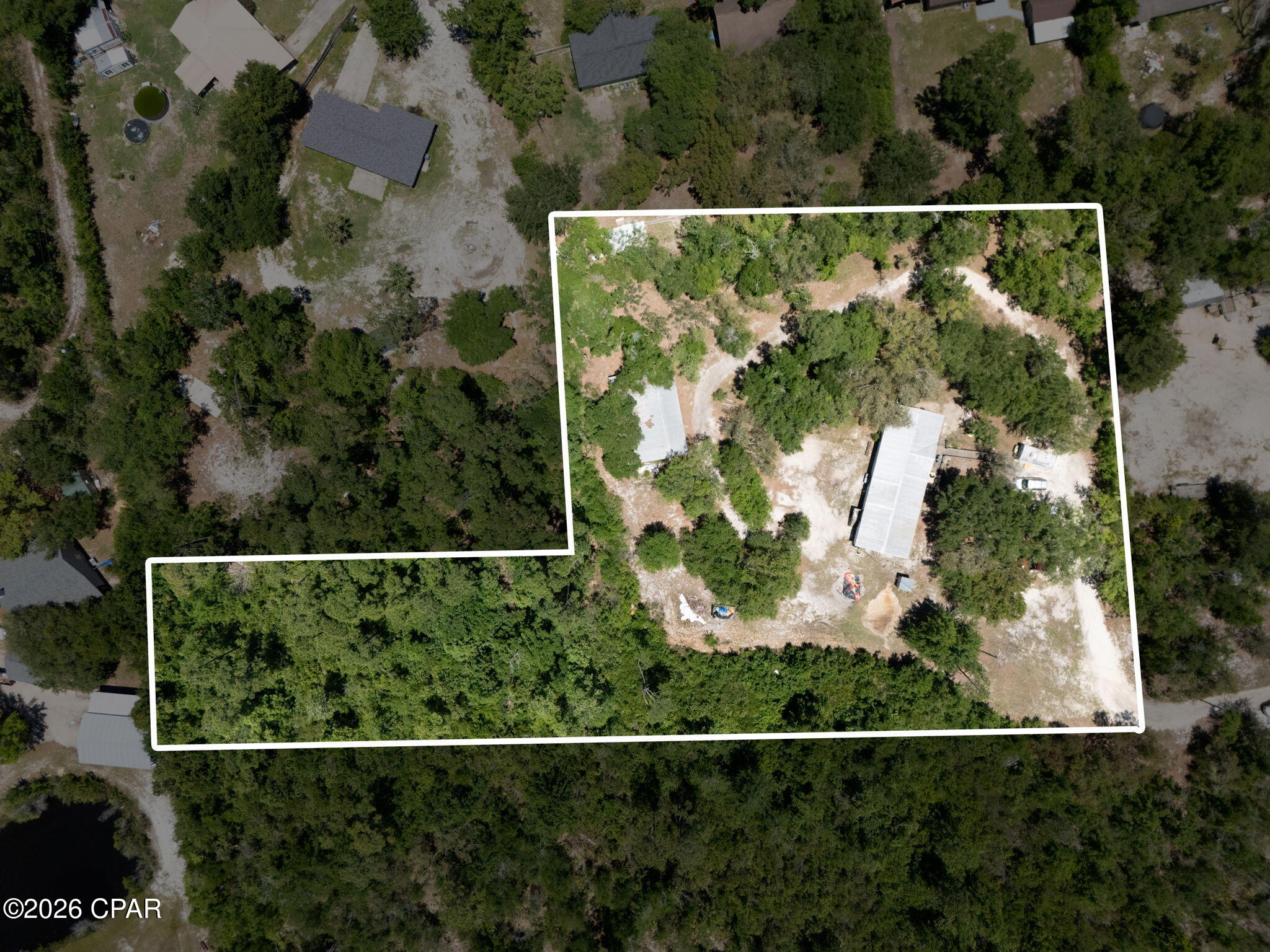 'CURRENTLY UNDER CONTRACT, SELLER WILL CONSIDER BACKUP OFFERS' Situated on 2.5 expansive acres in desirable Southport, 8325 Resota Beach Dr offers endless potential with plenty of room to create your ideal homestead, investment property, or private retreat. This large 4-bedroom home also features valuable flex space perfect for a home office, playroom, guest area, or additional living space to fit your needs. The guest bathroom has been renovated!!! The backyard features a 32x48 Pole barn with attached room and has electric & water already connected! With spacious interiors and a prime location near boat ramps, shopping, dining, and Panama City amenities, this property combines privacy with convenience. With acreage, size, and versatility, this property is packed with possibilities for the right buyer.