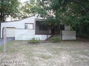 PRICE REDUCED !! Cottage style home located in Compass Lake community with view of lake. Home has 2 large bedrooms with split design and each has it's own porch that faces the lake. Each bedroom has it's own bath! There is a large rear deck with gazebo and a 1 car attached garage plus a 2 car detached garage/workshop equipped with 220 electricity. Across the back is a large den that overlooks the deck and gazebo. Some updates needed but a home with potential!