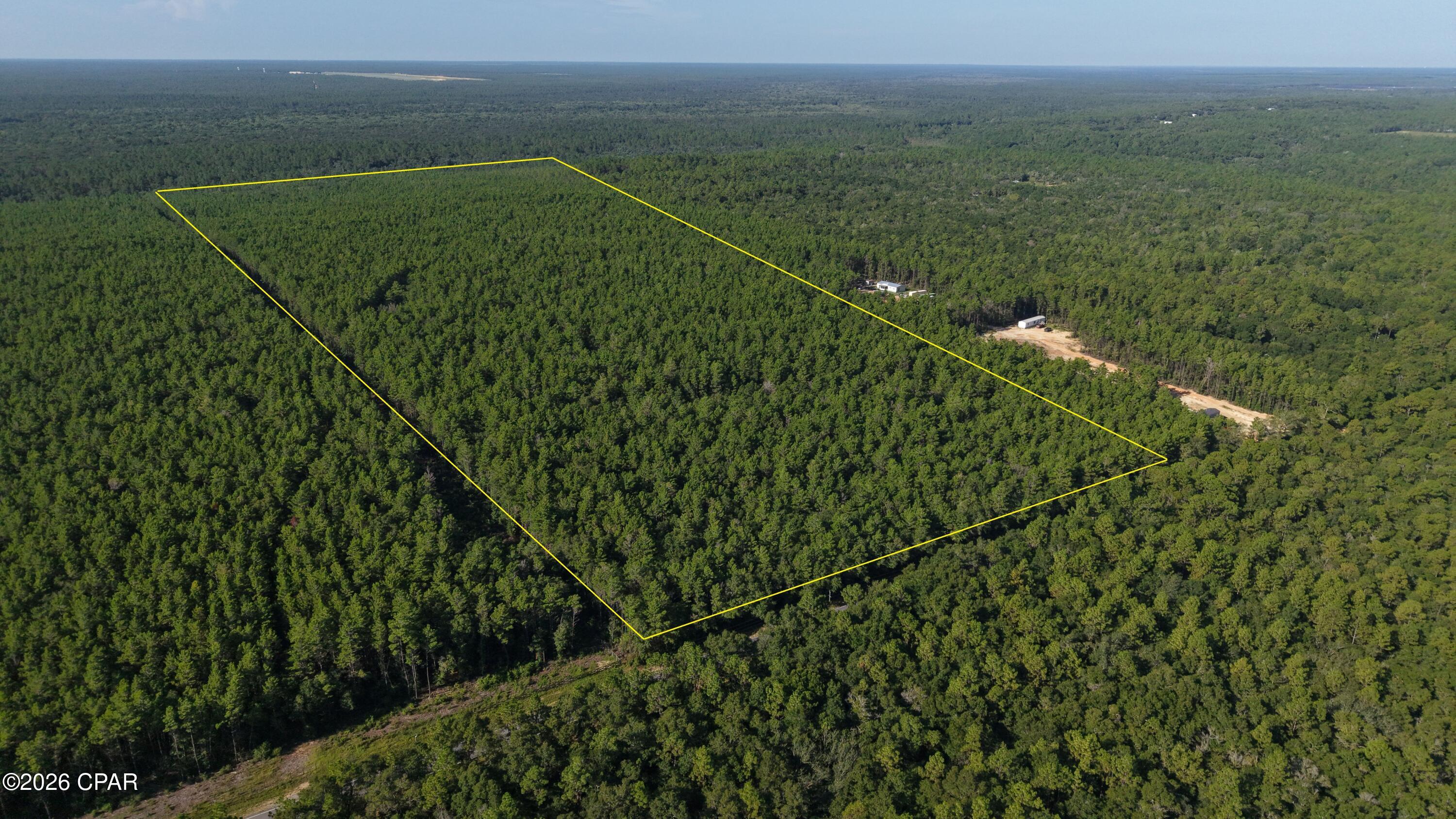 Are you looking for a spectacular property in which to build a home, recreate, or hunt? Then don't miss out on this rare opportunity to own approximately 70 magnificent acres of mostly high and dry ground that borders the pristine, state-protected lands of the Yellow River Management Area. Situated along paved road frontage, the property features a lengthy trail system that meanders through a large stand of natural-growth timber. The splendid beauty of the land itself makes it an outstanding place to build your future home. Both power and water are available roadside, providing an added bonus for those looking to build. Adding to the uniqueness of this property is its proximity to the vast Yellow River basin. Considered a biodiverse ecosystem and floodplain, the Yellow River basin spans more than 28,000 contiguous acres and encompasses a twenty-mile stretch along the Yellow River. Situated downhill and to the south of the subject property, the nearly impenetrable swampland of the Yellow River provides added privacy while serving as ideal habitat for a multitude of wild animals that venture out of the swamp and roam freely on this upland neighboring land. With that said, recreational opportunities such as hunting, hiking and land management abound within this naturally wild place. Regardless of its private and secluded setting, the property is conveniently located just a few short minutes from Interstate 110 and approximately 20 minutes from the thriving city of Crestview. And don't forget about the world-class beaches of the Emerald Coast which are less than an hour's drive away. Additional land may still be available. Give us a call today and don't miss out on this untamed tract of Florida land.