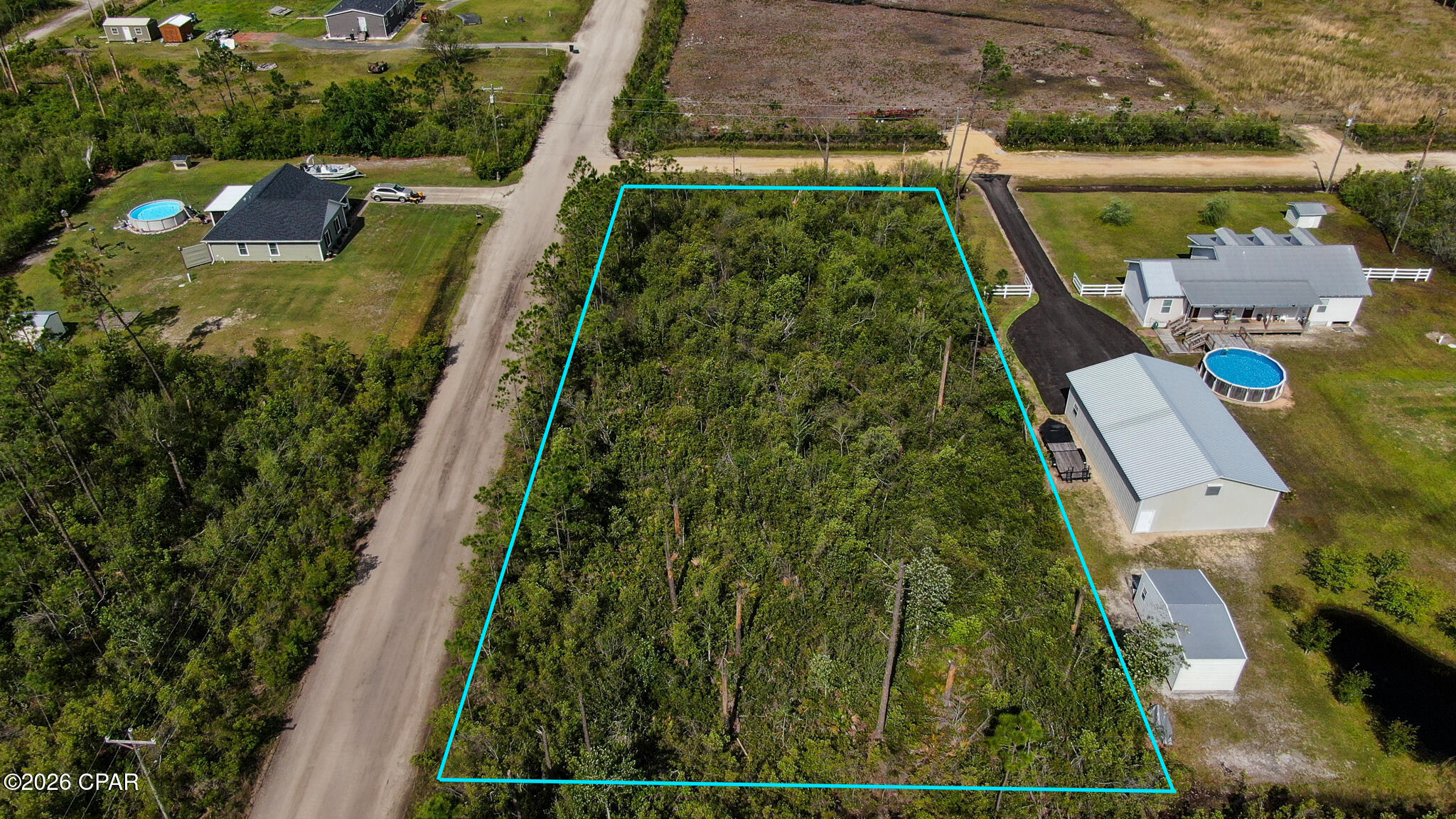 Property is raw land, uncleared. It's a 1 acre corner lot with electrical service at the street. The property has no mailing address. Next door neighbor address is 2201 BJ Drive.  Buyer should verify all zoning, measurements and land uses plus all other information deemed important.  Property is in a flood zone. Property is on a dirt road less than a mile to the paved road.