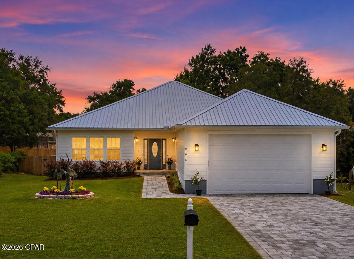 Exceptional craftsmanship, unmatched storage, and coastal living come together in this one-of-a-kind 2024 custom-built home on the highly sought-after west end of Panama City Beach. Designed to withstand the elements while delivering everyday luxury, this remarkable property offers the rare combination of Category 5-rated construction, dual primary suites, an oversized RV/boat garage, and modern efficiency--all just minutes from the beach, Lake Powell, and Camp Helen State Park. 
Inside, you'll find an open-concept floor plan with 9-foot ceilings, 8-foot solid wood doors, luxury vinyl plank flooring throughout, and enhanced wall insulation for exceptional sound reduction between rooms. Two spacious primary suites make this home ideal for multi-generational living, guests, or flexible living arrangements. Each features a spa-inspired ensuite bath, walk-in closet, solid wood doors with key locks, and private access to the screened porch and elevated back deck.
The oversized 28' x 30' (840 sq. ft.) garage with 12-foot ceilings and a 10-foot garage door provides ample room for an RV, boat, workshop, or multiple vehicles. An extra-wide, extra-long paver driveway accommodates up to four additional vehicles. Practical features include mop sinks in both the laundry room and garage, along with an energy-efficient circulating instant hot water system that delivers hot water quickly while reducing water waste.
Step outside to enjoy the screened porch and elevated deck overlooking the generous 80' x 150' lot, offering plenty of room to add a swimming pool while still leaving space for RV or boat parking.
Located just minutes from Lake Powell Park, you'll have easy access to a public boat ramp, paddleboarding, playground, picnic pavilion, and one of Florida's largest coastal dune lakes. Nearby Camp Helen State Park offers miles of scenic hiking trails, kayaking, fishing, and pristine Gulf beaches. You'll also appreciate the convenient access to the white sand beaches of Panama City Beach, 30A, shopping, dining, and entertainment.
This exceptional home combines luxury, functionality, and superior construction in one of Panama City Beach's most sought-after locations. Schedule your private showing today!