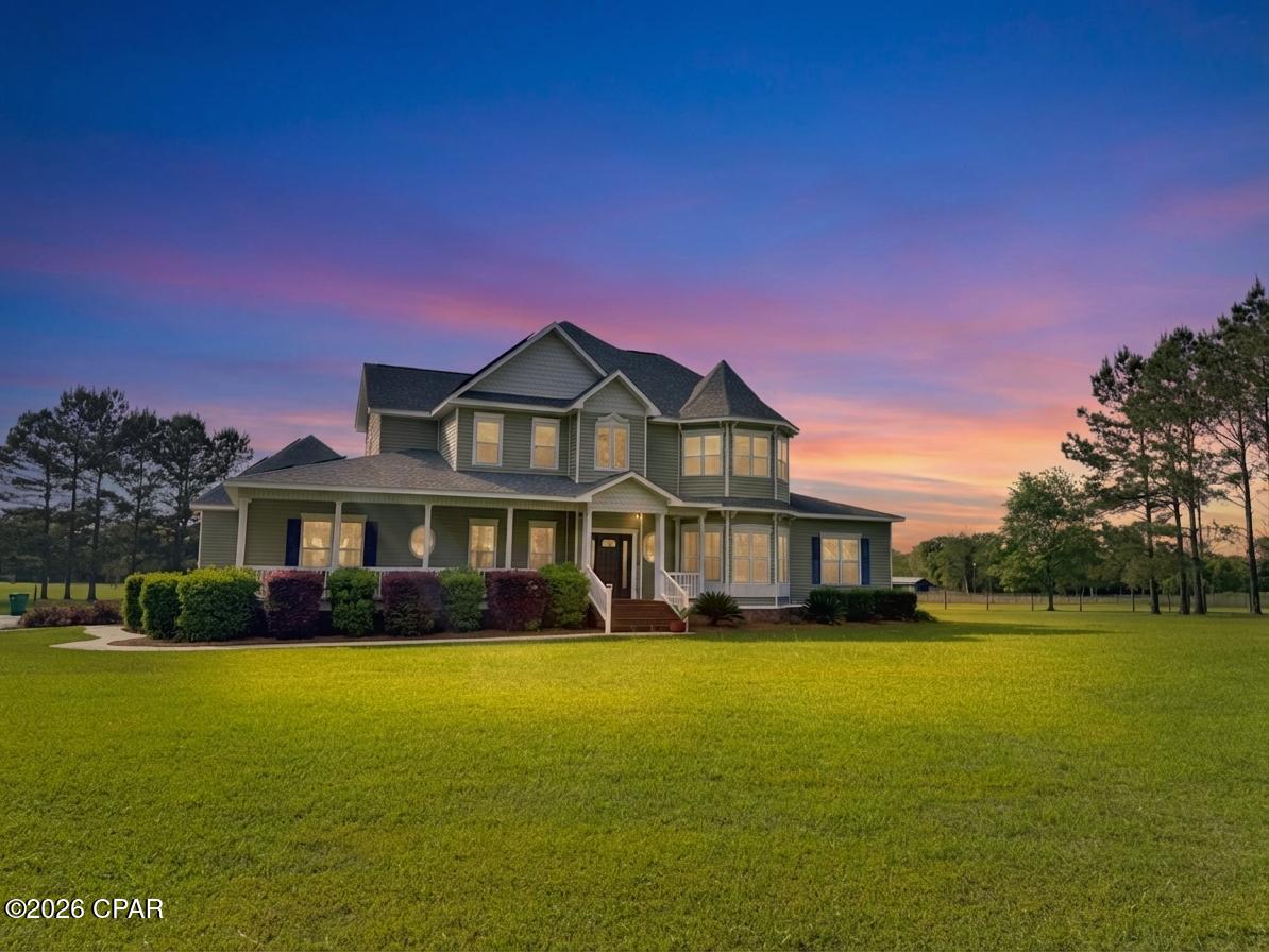 Welcome to your private estate in Graceville, Florida--where timeless Victorian charm meets modern comfort on 14.63 beautifully maintained acres. Fully fenced and cross-fenced with 4 paddocks allowing for easy rotational grazing, this exceptional property is perfectly suited for horses, livestock, or anyone seeking space, privacy, and functionality.

The centerpiece is a stunning Victorian-style home featuring soaring two-story ceilings in the main living area, creating a grand yet inviting atmosphere with views of the upstairs balcony and loft. Rich hardwood floors flow throughout much of the home, enhancing its warmth and character. Thoughtfully designed custom built-ins in the kitchen, mudroom, and living room add both style and practicality.

French doors open to a massive back deck overlooking the fenced backyard and sparkling in-ground saltwater pool--perfect for entertaining or relaxing in your own private oasis.

The main home offers 3 bedrooms and 2 bathrooms on the first floor, while upstairs you'll find a spacious 4th bedroom, full bath, loft living area, and a dedicated office--ideal for guests, work-from-home needs, or multi-generational living. The home also showcases an oversized 2 car garage for added convenience!

Just steps away, a fully equipped mother-in-law suite provides additional flexibility with its own kitchen, full bathroom, open-concept layout, and a large covered patio beside the pool.

Equestrian and agricultural amenities abound, including a 65x60 enclosed barn with 3 stalls, a 36x36 pole barn, and an additional storage shed for convenience. A line of mature plantation pines between the home and road enhances both privacy and curb appeal, creating a truly picturesque setting.

Recent upgrades provide peace of mind and efficiency, including solar panels that are already paid for, a roof replacement in 2020 on both structures, and 3 main HVAC units replaced in 2026. The sunroom is also equipped with its own mini-split system for year-round comfort. A survey is available for added confidence.

This one-of-a-kind property offers the perfect blend of elegance, functionality, and rural tranquility--ready for you to call home.
 (additional 1.67 acre tract w/ its' own well, septic, and power pole can be negotiated as well)