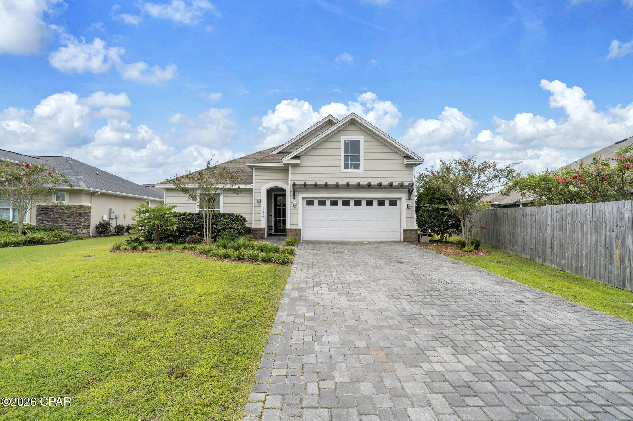 VA ASSUMABLE LOAN AT 2.75% for a qualified buyer! That alone makes 1186 Eisenhower Circle worth a closer look. This 3-bedroom, 2-bath home with a bonus room in Lynn Haven, Florida offers more than 2,200 square feet, beautiful hardwood flooring, a fully fenced backyard and an expanded outdoor living space designed for enjoying Florida year-round. Built by Arthur Rutenberg, this home has been beautifully maintained and thoughtfully updated with an open floor plan that gives you plenty of room to gather and spaces to spread out.
One of the updates you'll notice immediately is the flooring. Hardwood has been added to all three bedrooms to match the existing hardwood throughout the main living areas, giving the home a seamless look with no carpet. Coordinating LVP was added to the bonus room, creating flexible space for an office, media room, playroom or additional living area. Crown molding, tray ceilings, recessed lighting, custom window treatments and large windows add to the bright, finished feel throughout the home.
The kitchen is right at the center of it all, opening to the living and dining areas and featuring white cabinetry, granite countertops, stainless steel appliances, a large pantry and an oversized island with plenty of seating. It's an easy layout for everyday life and even better when everyone ends up gathered around the kitchen.
The primary suite offers a spacious bedroom, walk-in closet and private bath with double vanity and tiled walk-in shower. Two additional bedrooms and the bonus room give you plenty of options for how you use the space.
But don't stop at the back door. The outdoor living space has been significantly expanded with a large patio, sail coverings for shade and added privacy, creating a great place for grilling, dining or simply relaxing outside. Even with the expanded patio, there's still a large, fully fenced backyard with plenty of room to enjoy.
Additional features include a two-car garage with Tesla/EV charger, paver driveway, brick accents, attractive landscaping and a tankless water heater.
A 2.75% assumable VA loan, more than 2,200 square feet, no carpet, bonus room, fenced backyard and expanded outdoor living--1186 Eisenhower Circle offers a combination that's hard to overlook. Come see how well this Lynn Haven home lives.