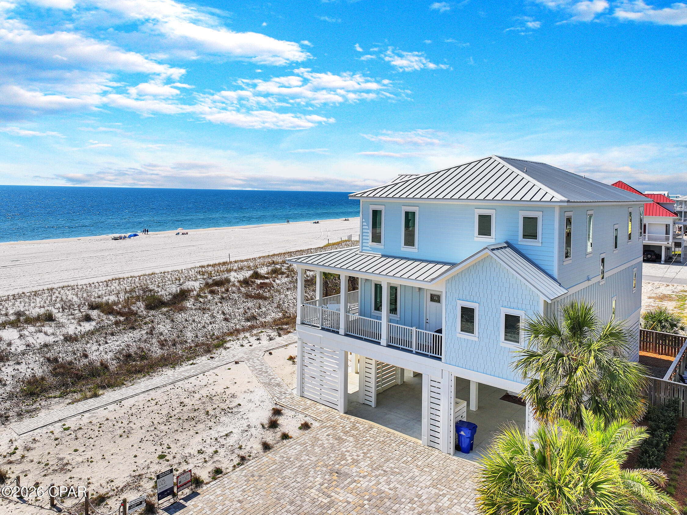Exquisite Mexico Beach Gulf Front coastal retreat blends contemporary sophistication with timeless charm, thoughtfully designed to embrace its breathtaking surroundings. Built in 2022 using advanced Insulated Concrete Form (ICF) construction, the home offers superior durability, efficiency, and modern design. Featuring five spacious bedrooms, four full baths, and two half baths, this residence provides ample space for family and guests. A private elevator services all levels for added convenience. The main living floor showcases a stunning great room with panoramic Gulf views and seamless access to an expansive beachfront deck--perfect for entertaining or enjoying unforgettable sunsets. The gourmet kitchen is equipped with premium appliances, custom finishes, and a generous breakfast bar, ideal for gathering and hosting. Adjacent, the inviting living area features a ventless gas fireplace and an impressive 85'' television for cozy coastal evenings. The primary beachfront suite is a true retreat, offering direct deck access, sweeping Gulf views, a spacious walk-in closet, and a spa-inspired en suite bath. The second level includes an additional family room, three private suites with en suite baths, and a versatile fifth bedroom perfect for a bunk room or office. As an added bonus, the home includes a private golf cart--ideal for cruising to nearby shops, restaurants, and the soon-to-arrive grocery store. This exceptional Gulf-front property offers luxury, comfort, and the ultimate coastal lifestyle.