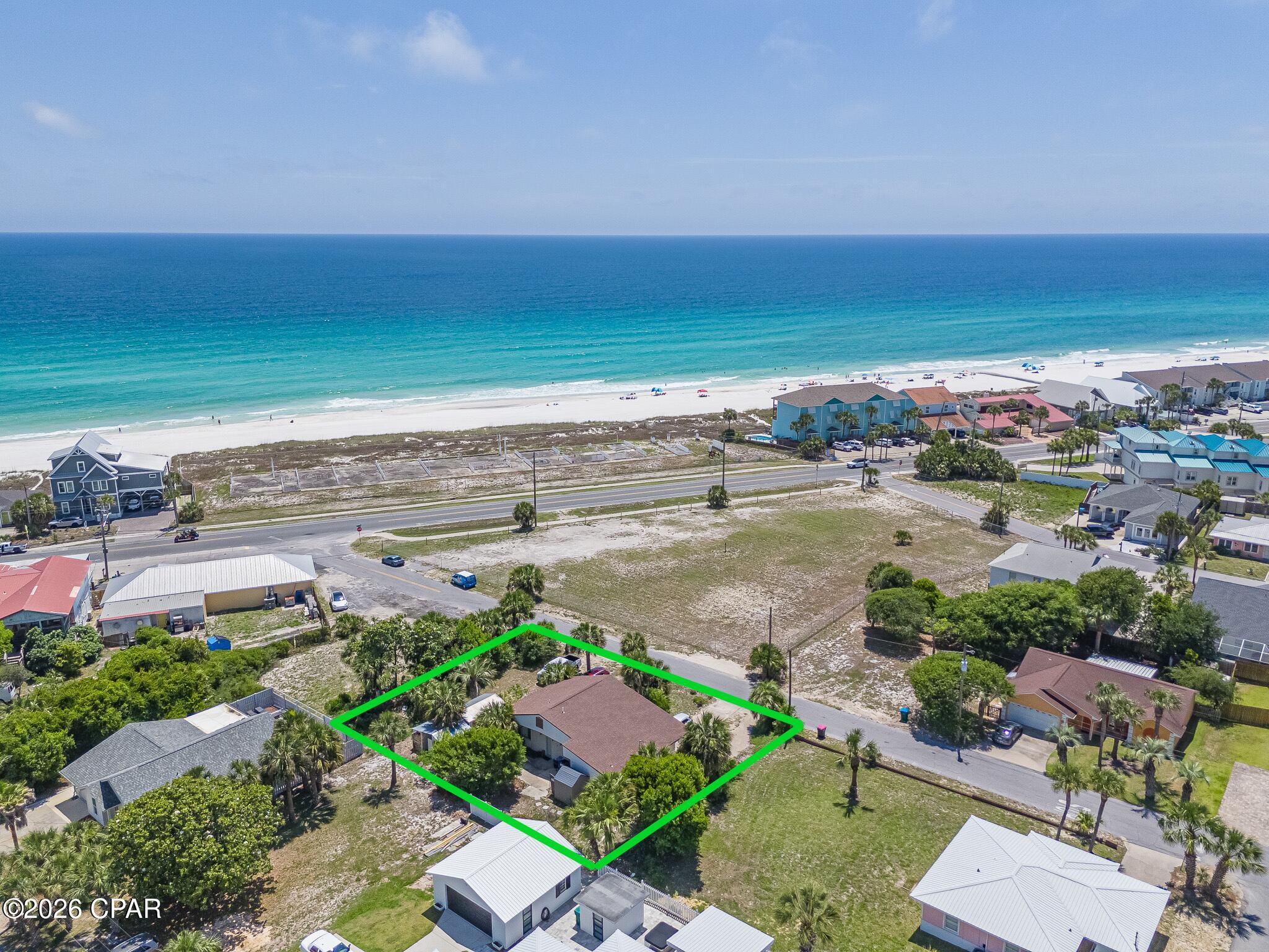ATTENTION 1031 EXCHANGE BUYERS, INVESTORS, DEVELOPERS, & DESIGN ENTHUSIASTS: This is not just a beach lot--it is an active, cash-flowing asset with massive structural equity and huge development upside. Located less than 400 feet from the sand in Panama City Beach proper (Miramar Heights) with protected, elevated Gulf views, this rare 0.24-acre double lot offers an immediate return on investment alongside future development flexibility.
THE CASH FLOW & INVESTMENT:
 • Turnkey Revenue: Proven 4-year rental history averaging $3,425/month in gross income.
 • Immediate Income: Current reliable tenants are already in place, making this an ideal, seamless vehicle for 1031 exchange placement from day one.
 • The Layout: Set up as a highly functional, income-producing configuration featuring a 2BR/1BA main home plus a completely separate, private-entrance studio apartment with its own kitchen and full bath. 
THE ARCHITECTURAL VALUE:
Forget cookie-cutter beach builds. The existing structure is a rare, mid-century modernist jewel built in the classic California Eichler style. It features stunning original terrazzo floors, striking tongue-and-groove cathedral wood ceilings, and timeless stucco construction. A preservationist's dream beach retreat or a luxury hybrid rental space with unparalleled character.
THE DEVELOPER / ASSEMBLAGE OPPORTUNITY:
Zoned R-1c and situated entirely in a preferred Flood Zone X (no flood insurance required by Lender!). Because the structure sits on an oversized double lot, there is an opportunity to be subdivided into two premium buildable lots with Gulf views. Crucially, this property is surrounded on all sides by vacant lots, creating a rare and highly lucrative potential assemblage play for an investor looking to capture a massive, continuous footprint on the quiet west end of PCB.
Whether you choose to collect the steady $3,400+/month check, restore a mid-century modernist masterpiece with a resort-style pool yard, or leverage the surrounding vacant parcels for a major development play, the ceiling on this property is incredibly high. Sold as-is. Do not disturb tenants. Buyers to verify all dimensions and zoning specs.