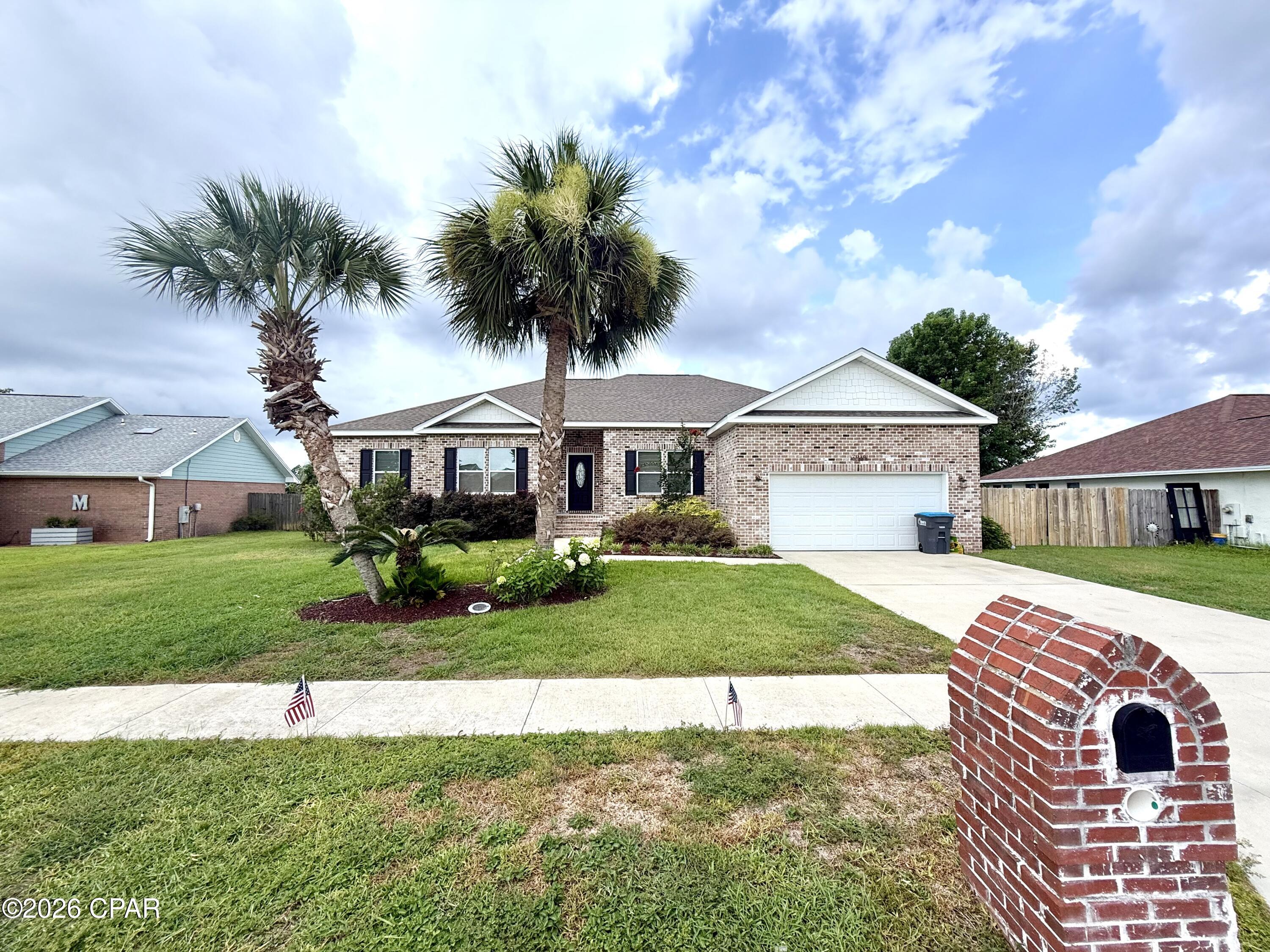 Welcome to 7016 Benton Drive in Panama City, FL! This 4 bedroom, 3 full bathroom brick home offers 1,993 square feet of well-designed living space on a 0.26 acre lot in the Callaway Point subdivision with no HOA. Built in 2021, the home features an attractive brick exterior, 2-car attached garage, covered front entry, and a functional layout with comfortable indoor and outdoor living areas. Inside, you'll find an open main living area with tray ceiling detail, recessed lighting, and easy flow into the kitchen, breakfast nook, and formal dining area. The kitchen features white cabinetry, a center island with bar seating, pendant lighting, tile backsplash, and stainless appliances, including refrigerator, dishwasher, microwave, and electric range/oven. The primary suite includes a tray ceiling, walk-in closet, and private bathroom with double vanity, soaking tub, tiled walk-in shower, and separate water closet. Three additional bedrooms and both of the other full bathrooms provide flexibility for sleeping space, office use, guests, hobbies, or storage. The fully fenced backyard includes a screened-in back porch and a 13 ft x 13 ft pole barn that can be used for covered storage, grilling, outdoor seating, or entertaining. Conveniently located less than 8 miles from Tyndall Air Force Base and less than 3 miles from two public boat ramps, this Bay County home offers quick access to Panama City, Callaway, local waterways, and everyday conveniences.