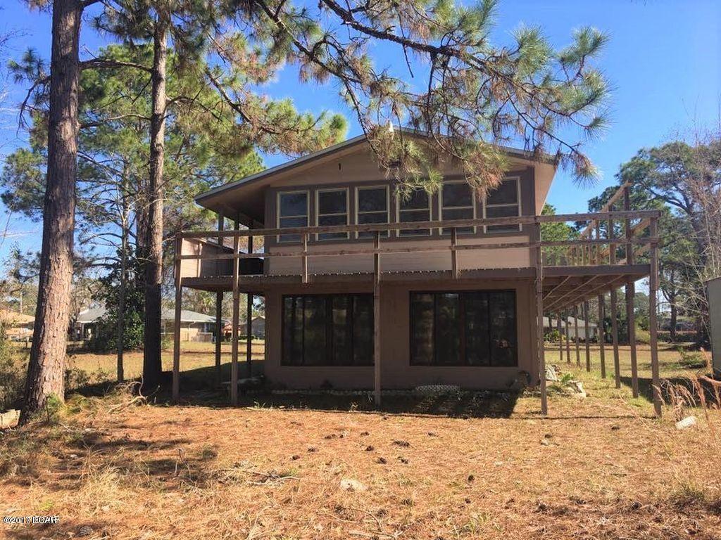 Waterfront!!  Almost 1 acre on the canal just a few paddles to the bay and beach. Private boat ramp…. fish, kayak, and boat all from your back yard.  Nice walk around deck and great sitting room both with beautiful views of the water. House has solid oak floors and open kitchen area with lots of cabinet space. Quiet neighborhood and close to Tyndall!