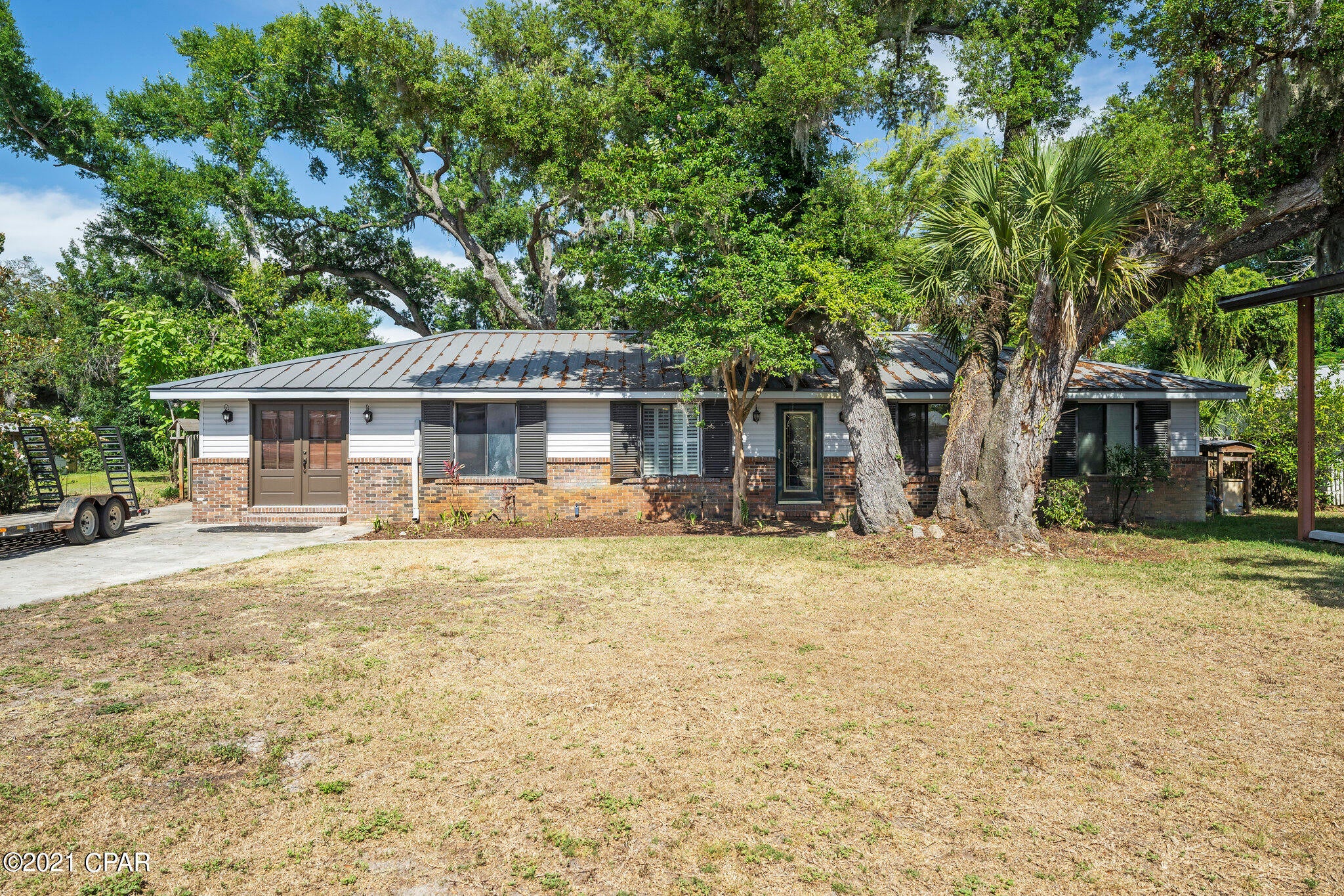 'CURRENTLY UNDER CONTRACT, SELLER ACCEPTING BACKUP OFFERS -This pool home is within walking distance to beautiful St. Andrews Bay(1 block), and is nestled among Heritage Oak trees in the heart of Panama City.  Enjoy all that St. Andrews has to offer with great restaurants, a marina with public boat ramp, farmers market and shopping.  With plenty of room for guests or a larger family, this home includes two master suites that open to the screened in pool area.  Besides 4 bedrooms, there is also an office and another craft/hobby room that could be a 5th bedroom.  The kitchen boasts all wood cabinets with granite countertops and the living room is adorned with a beautiful wood vaulted ceiling and gas fireplace. Enjoy hot summer days in the pool or take an 8 mile drive to the white sandy beaches of St. Andrews State Park.  The tankless gas water heater is 10 years old, home has a new HVAC, & the metal roof is 6-7 years old.  Easily access your RV or boat under the pole barn.  The 34x18 detached garage/workshop is equipped with shelving and electricity.    If measurements deemed important, please measure.
