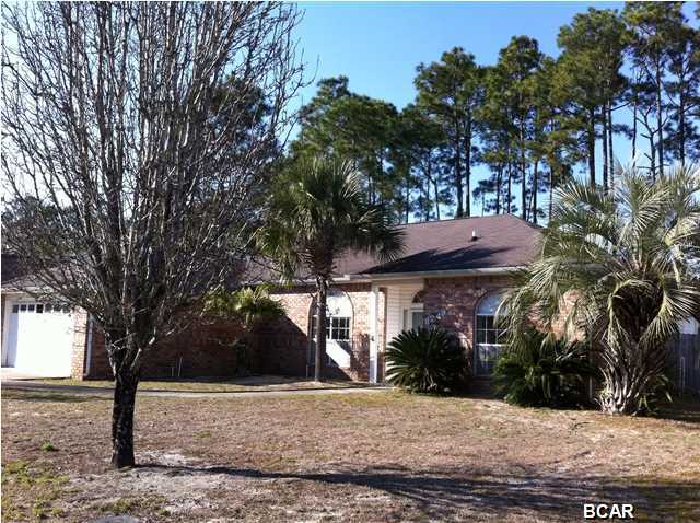 This great home is located close to Tyndall AFB and town. Contemporary in style, the home offers a nice open, split bedroom floorplan with 10 ft ceilings in the great room and a 12 ft tray ceiling in the master bedroom. The entry leads into a comfortable, roomy living area with wood burning corner fireplace. The spacious formal dining room is perfect for having friends over. The large kitchen offers a breakfast bar and adjoining breakfast room. The kitchen, with generous counter space, has lots of cabinets. The spacious master bedroom has his and hers walk-in closets. The huge master bath has a double vanity, separate shower and jetted tub. There is a spacious laundry room with built-in cabinets and enough space for an extra refrigerator or freezer.