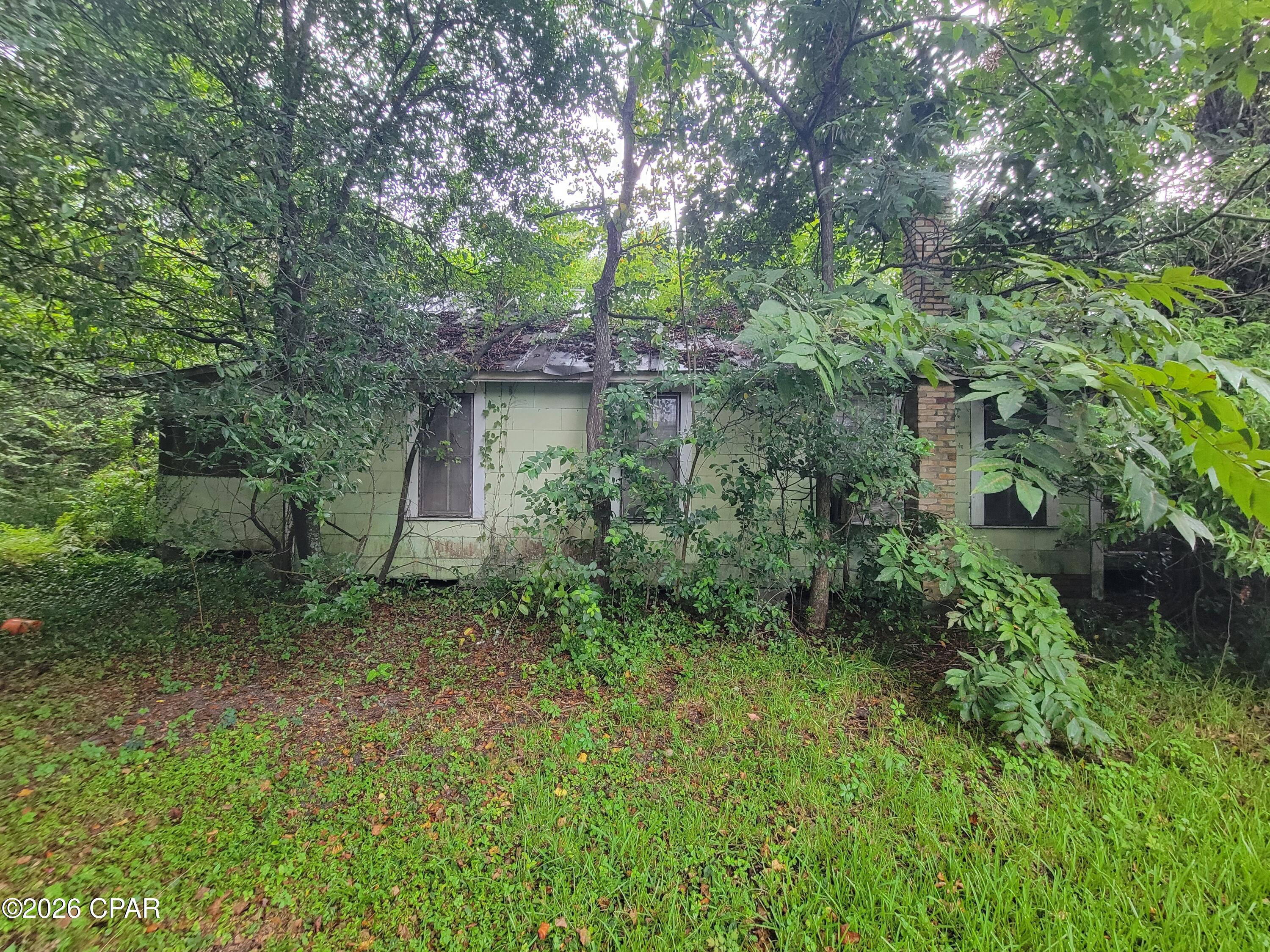 Opportunity on a paved city street! This property is situated on a small lot with access to city water and sewer. With some clearing and cleanup, this property offers potential for someone looking for an affordable project or investment opportunity. Convenient in-town location with public utilities already available.