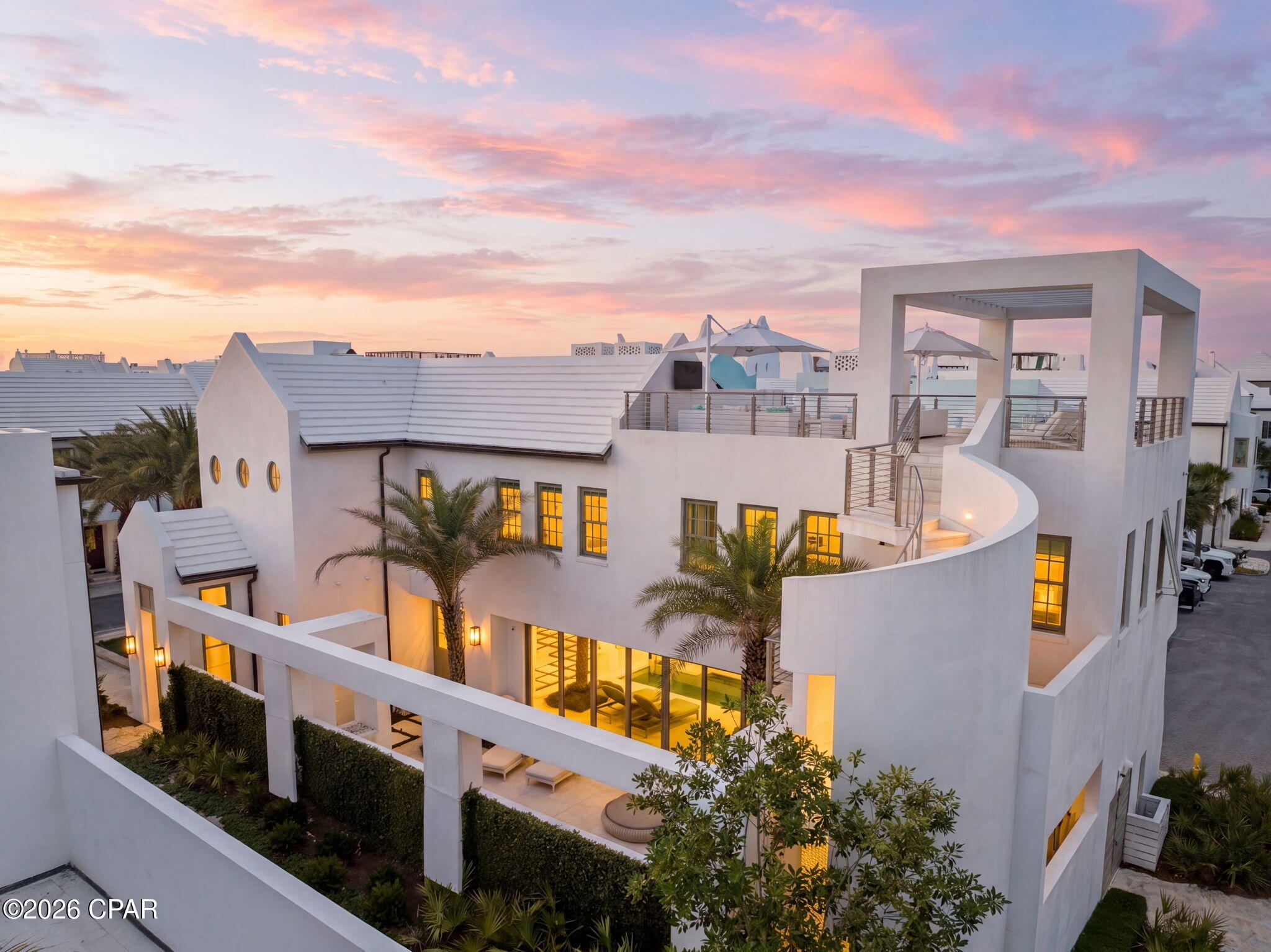 62 S. Charles Street is a striking contemporary residence designed by renowned A Boheme Design, blending modern luxury with the tranquility and natural beauty of Palmera Park. Ideally located south of 30A, this exceptional home embraces park views while remaining just moments from the Gulf green and sugar-white sands. 

A private sanctuary concealed behind white stucco walls and sculptural structural columns, the residence was thoughtfully designed to accentuate its bold architectural lines and lush landscaping. Every detail creates a seamless connection between modern artistry, coastal elegance, and serene outdoor living.

Thoughtfully designed for both full-time living and effortless entertaining, the home offers 3,845 square feet of conditioned living space with expansive indoor and outdoor living areas. Featuring four bedrooms, including two luxurious primary suites, two guest suites, laundry rooms on each level, and a media room with wet bar, every detail was curated for comfort and sophistication. 

The heart of the home showcases an open-concept kitchen, dining, and living area seamlessly connected to the outdoor courtyard and pool through dramatic 30-foot multi-slide glass doors, creating a true indoor-outdoor living experience. The gourmet kitchen is beautifully appointed with a large island, a 48-inch Miele range, Sub-Zero refrigeration, wine cooler, and icemaker. Imaginative design details continue throughout the home, including a stunning book-matched marble fireplace that beautifully complements the countertops, while custom finishes inside and out add layers of architectural intrigue. 

The outdoor spaces are nothing short of spectacular. A 32-foot water wall cascades into the length of the pool, complemented by a gas fire pit and covered summer kitchen featuring a Wolf grill, Sub-Zero refrigerator, and icemaker. The surrounding outdoor living areas and plunge pool cultivate an atmosphere of refined leisure and elevated coastal living.

A sculptural concrete helicoidal staircase leads to the third-floor rooftop terrace where beautiful sunset vistas and iconic views of Alys Beach architecture await. Entertaining and relaxation are elevated by the abundance of thoughtfully designed indoor and outdoor gathering spaces.

Both primary suites overlook the serene beauty of Palmera Park and feature spa-inspired bathrooms with floor-to-ceiling marble, dual vanities, expansive showers, and spacious walk-in closets. The first-floor primary suite also enjoys a private courtyard with a whimsical outdoor soaking tub, offering a tranquil retreat to relax and unwind while embracing the peaceful ambiance of the surroundings.

Interior finishes blend warmth and contemporary elegance, with shell stone flooring flowing throughout the first floor and continuing into the courtyard, while rich walnut flooring defines the second level. Twelve-foot ceilings throughout the first floor enhance the home's open, airy feel, while the dramatic floor-to-ceiling marble fireplace creates a stunning focal point.

Ascending to the second level, a striking zebra wood-clad stair hall with an Italian-made polished stainless-steel railing by Maretti introduces the media room, an additional primary suite, a conveniently located second-floor laundry room, and two spacious guest suites, each featuring beautifully designed baths and oversized closets.

Designed to elevate the coastal lifestyle, this residence offers the opportunity to enjoy the exclusive amenities of Alys Beach, highlighted by access to the private Beach Club--an exceptional retreat reserved for owners.