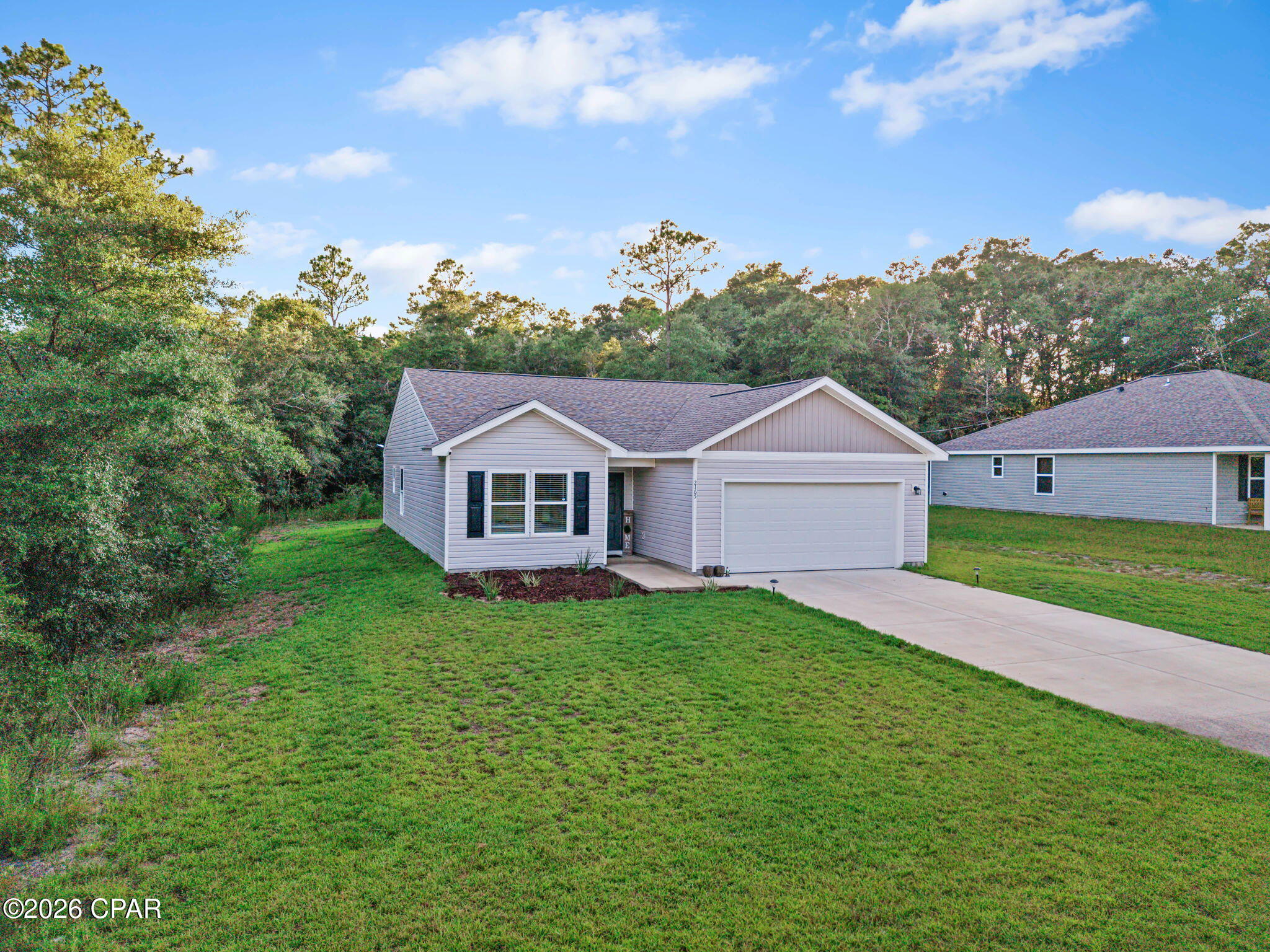 From days at the lake to afternoons on the golf course, this Sunny Hills home puts you close to the things that make living here fun! Step inside to a bright, inviting interior with an open layout that keeps the kitchen and living areas connected and comfortable. The kitchen features white cabinetry accented by contrasting hardware, granite countertops, stainless steel appliances, and plenty of workspace. Vinyl plank flooring, recessed lighting, and blinds throughout the home add to the clean, finished feel. The primary suite offers its own private bath with a double vanity and a large walk-in closet, while two additional bedrooms provide flexibility for family, guests, or a home office. A separate laundry room provides additional storage space, and the attached two-car garage gives you plenty of room for vehicles, outdoor gear, and more. Out back, the covered patio is a great place to enjoy your morning coffee or unwind while overlooking the wooded backdrop. Beyond the home, Sunny Hills offers plenty to enjoy, including Boat Lake Swim Park, outdoor recreation, and the Sunny Hills Golf Club. With its modern finishes, thoughtful details, great storage, covered outdoor space, and access to the recreational amenities Sunny Hills is known for, this home is one you'll want to see in person!