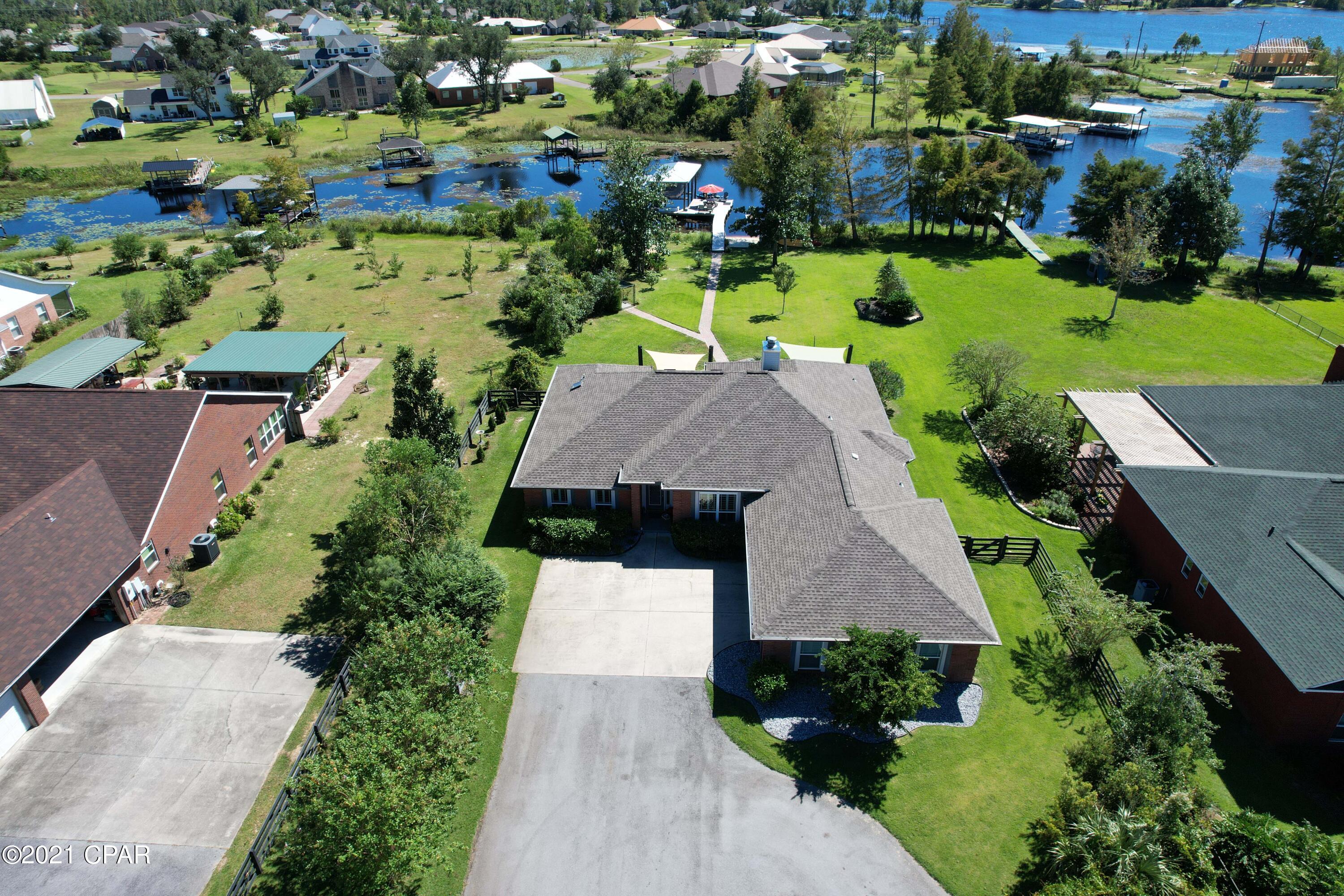 CURRENTLY UNDER CONTRACT, SELLER ACCEPTING BACKUP OFFERS.  Over 1.3 acres of waterfront bliss!!  This 4BR/2BA home on Deerpoint Lake is ready to go for boat and water lovers!  The 38' boat house has a 12,000lb lift which can accommodate up to a 25' boat and a 5500lb lift ideal for a pontoon boat!  This home is all set up for entertaining with a summer kitchen to die for with granite counters and rust-resistant grills and cookers, all covered with a sail shade!  There is another sail shade over the patio where you can enjoy amazing sunsets over the lake!  Additional outdoor amenities include a gazebo and a 22x36 workshop/garage with 125 amp service and roll-up doors.  Perfect man cave!  The interior of the home boasts quality craftsmanship and ... impeccable details such as step down step down crown molding, french doors, bay windows, hardwood and ttile flooring, and a split-bedroom floor plan.  The Kitchen has Corian countertops, stainless steel appliances and a separate pantry and breakfast nook.  The Master Suite overlooks the backyard and water and the adjacent bath features a double sink vanity, whirlpool tub, separate shower and a huge walk-in closet.  So much more we could mention, but this home is truly a must-see!
Water lovers will LOVE this home! All information approx and must be verified by buyers if important.