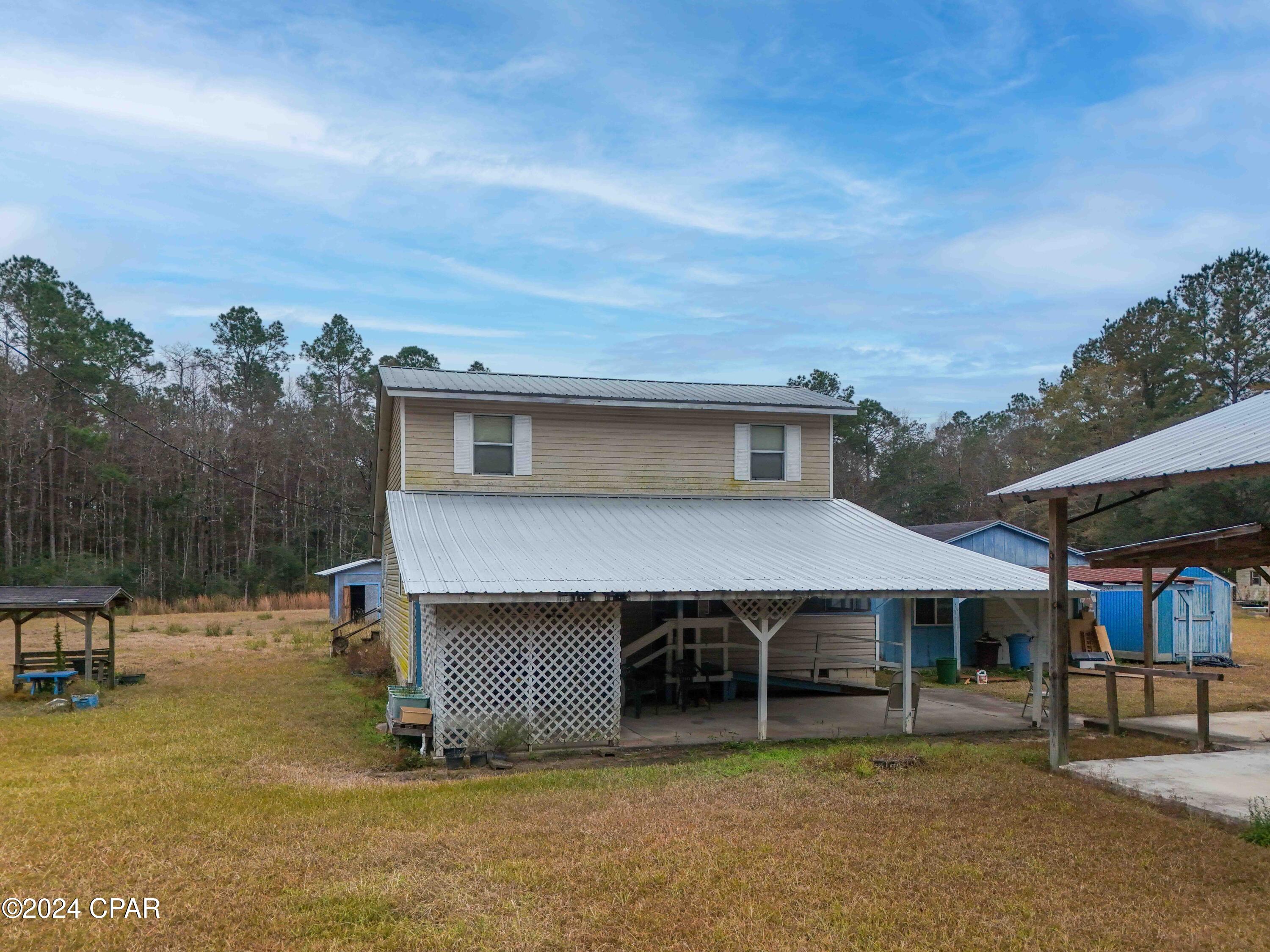 Welcome to 3964 Pate Pond Road--a fantastic starter home or investment opportunity overflowing with potential! Nestled on a private 3.62-acre lot in Vernon, FL, this country property features a spacious 1,884 sq. ft. layout with 3 generous bedrooms and 2 full bathrooms. Inside, you'll find an open living area, an eat-in kitchen with a gas range, vinyl flooring, and a convenient first-floor primary suite. Key functional upgrades offer peace of mind, including a metal roof and a newer HVAC system.

Outdoors, the property is tailored for hobbyists and outdoor enthusiasts alike, offering multiple sheds, pole barns, an attached carport, and a private backyard pond ideal for fishing. Located just 3 minutes from Holmes Creek for boating and kayaking, and only 35 minutes from the world-famous white sand beaches of Panama City Beach, this property combines quiet rural living with easy access to coastal amenities. Bring your vision to life and make this tranquil country retreat your own!