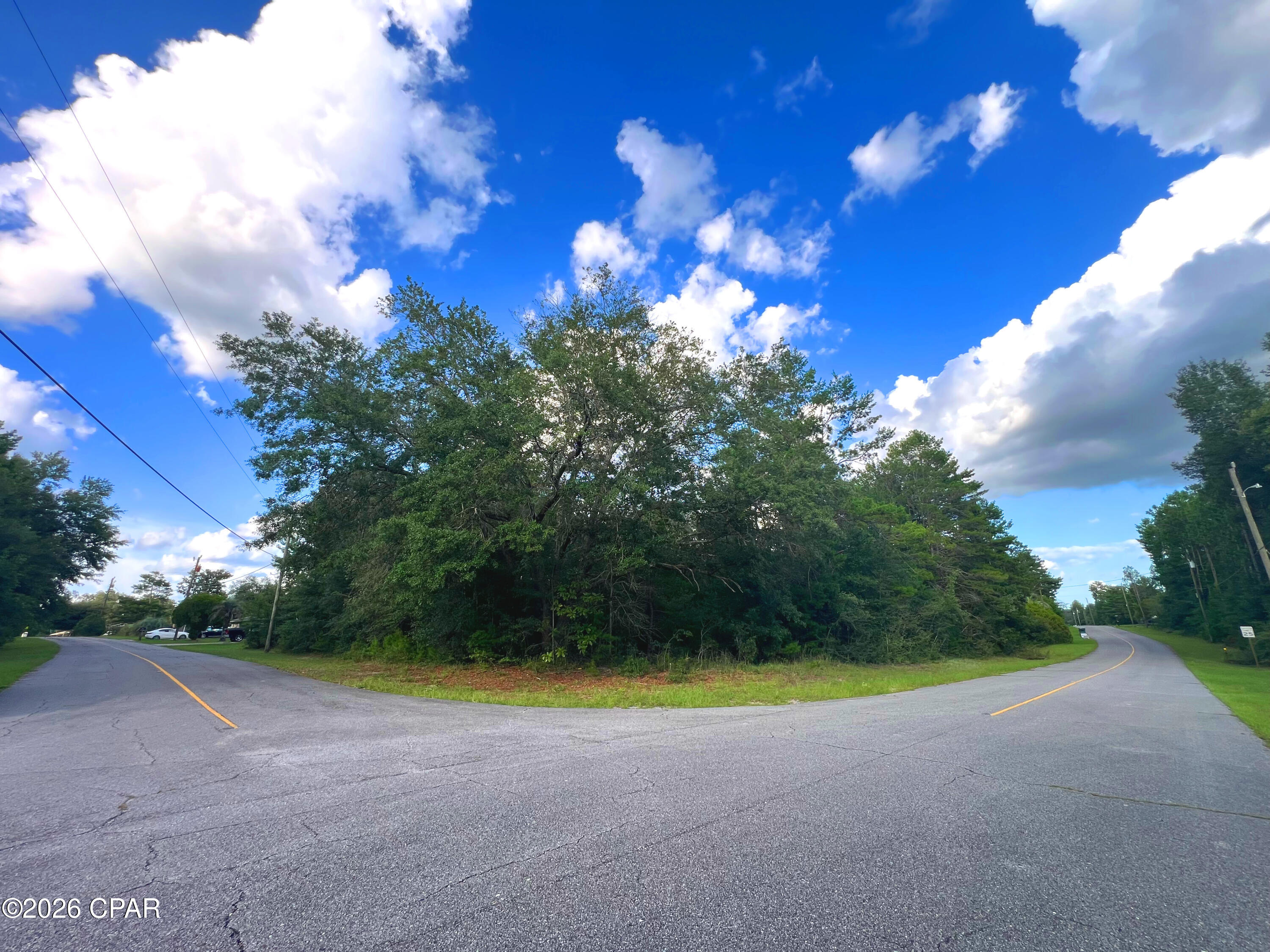 This EXCEPTIONAL Sunny Hills lot features beautiful lagoon oaks, and is less than 150 yards from spring fed Boat Lake through green space! With a large oak on the corner, and several more on the interior, this oversized corner lot is the perfect location for an idyllic Florida homestead! It is also one of the few lots available with access to boat lake through green space (owned by Deltona Corp for retention). A recreation area with facilities, pavilion, and picnic tables is just over half a mile away. Enjoy the white sand beach and clear spring water without the crowds at other springs and beaches. Sunny Hills is currently experiencing a revival, with lots of new construction and development taking place. The community has its own library, 18 hole golf course, and churches, but is still only 37 miles from Pier Park. *Buyer to verify zoning, utilities, setbacks, deed restrictions, and building requirements.