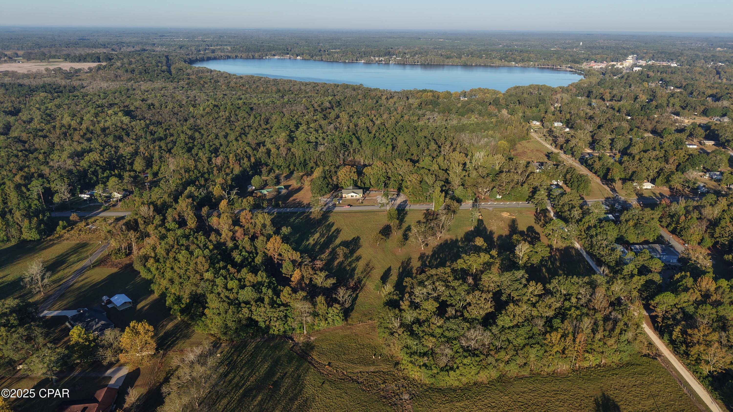 Position your business for success at this highly visible commercial opportunity located along the busy travel corridor of US Hwy 331 North. Zoned commercial, this mostly cleared and vacant property offers excellent exposure to consistent daily traffic commuting between Northwest Florida and South Alabama. The property's strategic location makes it ideal for retail, service, or development use. Situated at the Florida/ Alabama state line and within the city limits of both Paxton, FL and Florala, AL, the location provides unique cross-state appeal and accessibility.  Two established side streets to the north and south of the property allow for easy ingress and egress, which will undoubtedly enhance convenience for customers, deliveries, and daily operations. The property features a large, open ground area that is high and dry with established drainage, offering a strong foundation for future development. Power and water are available at the roadside, helping reduce upfront infrastructure costs and streamline planning. Whether you're expanding an existing business or developing a new commercial venture, this strategically positioned site offers visibility, access, and flexibility and all within a growing regional corridor. Don't miss this opportunity to secure a prime commercial location with outstanding potential for future business.