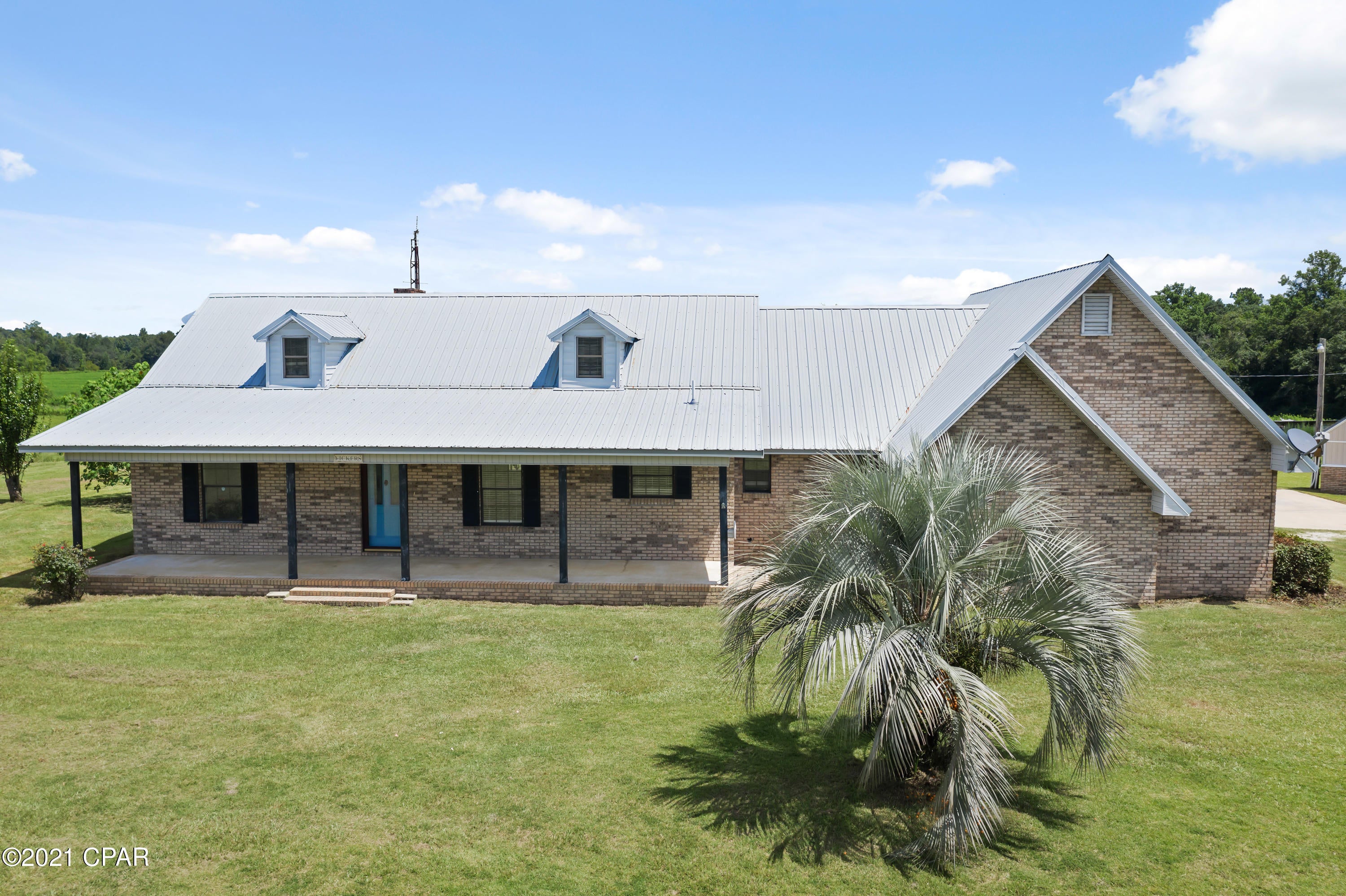 Looking for large home... in the country! Original home was 3 bedroom and owners closed in original garage and made into 2nd master or den area. Great Room open to kitchen and dining area. Large Florida Room on the back of home. Two car garage with additional  storage. Home has Metal roof!