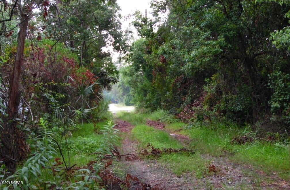 Beautiful somewhat secluded location to build your beach home. Land features almost .48 acre in county located between front and back beach roads. Present zoning is R2 single family homes only.