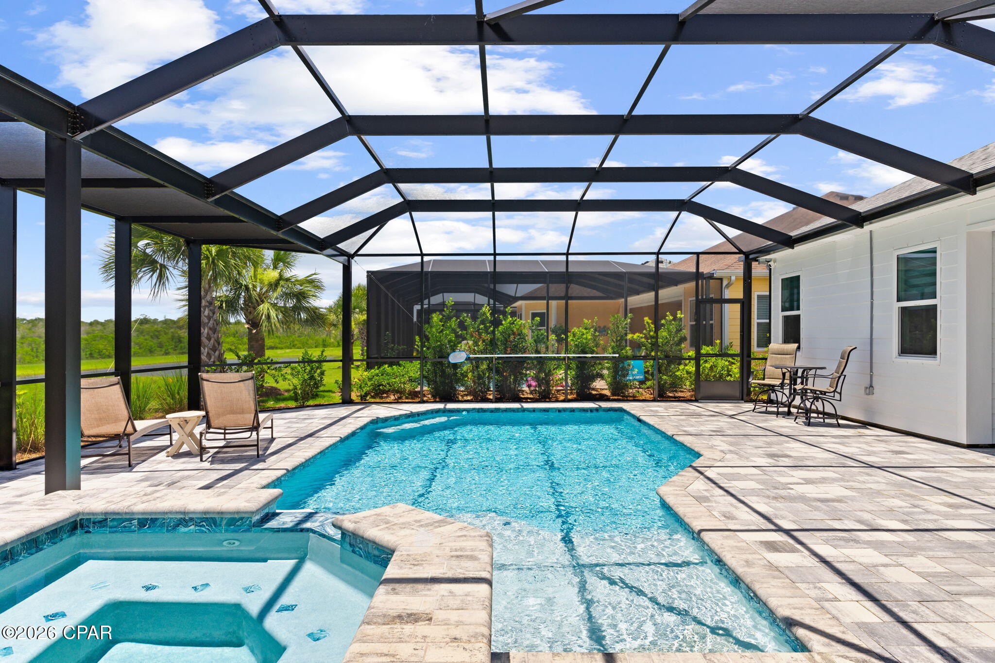 Paradise Isn't a Vacation...It's Home! Welcome to paradise in Latitude Margaritaville Watersound, the award-winning 55+ community where every day feels like a vacation. This exceptional Trinidad Bay with a heated saltwater pool/spa blends sophisticated design, luxury finishes, and effortless indoor-outdoor living. The stunning chef's kitchen is designed to impress with quartz countertops and backsplash, an oversized island, premium appliances including a gas cooktop, wall oven, microwave, and a custom walk-in pantry with spice rack. Entertaining is effortless as the kitchen flows into the dining area featuring a custom dry bar with beautiful tile, floating shelves, quartz countertops, and wine and beverage refrigerators. The inviting family room is a true showpiece, highlighted by a custom fireplace wall, handcrafted beams, illuminated floating shelves, and elegant framed grasscloth wall that showcases your favorite art piece. The private owner's suite overlooks the pool and offers blackout shades, custom closets and a spa-inspired bath with dual vanities, a zero-entry frameless shower, and upgraded floor-to-ceiling tile. Two guest suites each feature beautifully upgraded ensuite baths with Level 3 quartz and tile to the ceiling, while the den with French doors provides the perfect office or flex space. Outside, your private oasis awaits. Relax in the heated saltwater pool and spa, unwind on the extended lanai overlooking peaceful ponds, and enjoy breathtaking western sunsets surrounded by recently installed privacy landscaping. Practical luxury continues with abundant cabinetry and a secondary refrigerator in the laundry room, while the oversized three-car garage offers built-in storage cabinets, epoxy flooring, ceiling-mounted storage, and pull-down attic access. 8' doors throughout. Residents enjoy live entertainment/music, Paradise Pool, Bar & Chill restaurant, fitness center, indoor lap pool, pickleball, basketball and tennis courts, walking trails, dog park, dog spa, countless daily activities, and golf cart-friendly paths. Just minutes from shopping, dining, the upcoming public marina, the FSU/TMH medical campus. Approximately 7 miles from the sugar-white beaches of the Gulf, this home offers the perfect balance of luxury, convenience, and the carefree coastal lifestyle you've been dreaming of. Come see why this is more than a home--it's a lifestyle you'll never want to leave and where friends become family. 3 Months left of 2 year builder warranty!