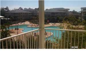 Experience an oasis at the beach. This is an executive 1 bedroom, 1 bath, 1069 sq. ft. condo with a study/office in the beautiful and tranquil gated community of Island Reserve, located off Front Beach Road in Panama City Beach. This open floorplan features hardwood flooring in the living area, tile in the kitchen and bathroom, and plush carpet in the bedroom and bonus study, all with 10' ceilings. The well appointed kitchen includes granite countertops and island, stainless steel appliances, and detailed cabinetry. Bonus amenities include washer and dryer, window coverings, private balcony and covered garage parking and entry. The Island Reserve community features gorgeous landscaped courtyards with paved walks and fountains. Club house boasts fitness center, media center,