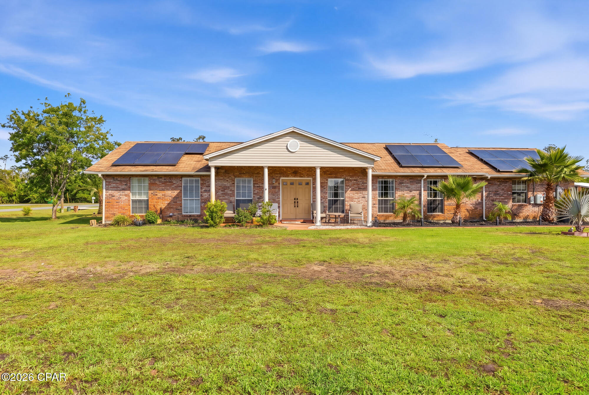 Well-maintained and move-in ready brick home situated on a spacious corner lot with fully paid-for solar panels, offering energy efficiency and potential savings from day one! This inviting property offers plenty of room to spread out with a formal living room, an open and spacious kitchen, and a cozy family room--ideal for both everyday living and entertaining.  The three bedrooms are generously sized with ample closet space, while the primary suite features a walk-in closet for added convenience. The glass-enclosed Florida room provides versatile bonus space perfect for relaxing, entertaining, or a home office (not included in the heated and cooled square footage) and was upgraded with all new sliding glass windows in 2019, allowing for abundant natural light and improved functionality.  Major updates include a new A/C system installed in 2024, giving buyers added peace of mind. The side-entry two-car garage features separate garage doors with openers, along with a spacious storage/workshop area. Outside, you'll find two storage sheds and a sprinkler system powered by its own well pump, making lawn care and outdoor maintenance a breeze.  Call to see today!