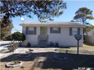 Don't miss out on a wonderful beach cottage or investment property. This home is in the very desirable West End of the beach. The home is a short walk to Lake Powell and the beautiful Gulf of Mexico. Close by is a Publix, Winn Dixie, Billy's Crab House, more shopping, not far from Pier Park, not much of a drive to 30A. You really have the best of both worlds. Home features an extra large gravel driveway, room for several large vehicles, boat, RV. it's 30x100 lots of room. A new covered porch, place to enjoy the quiet evenings. Yard has an 8' privacy fence in back. A workshop/ with power or make great storage also insulated. There is a boat ramp at Lake Powell, you can also go over to the beach from there on the Lake. Inside of home shows very well. Ready to move in. Wonderful first