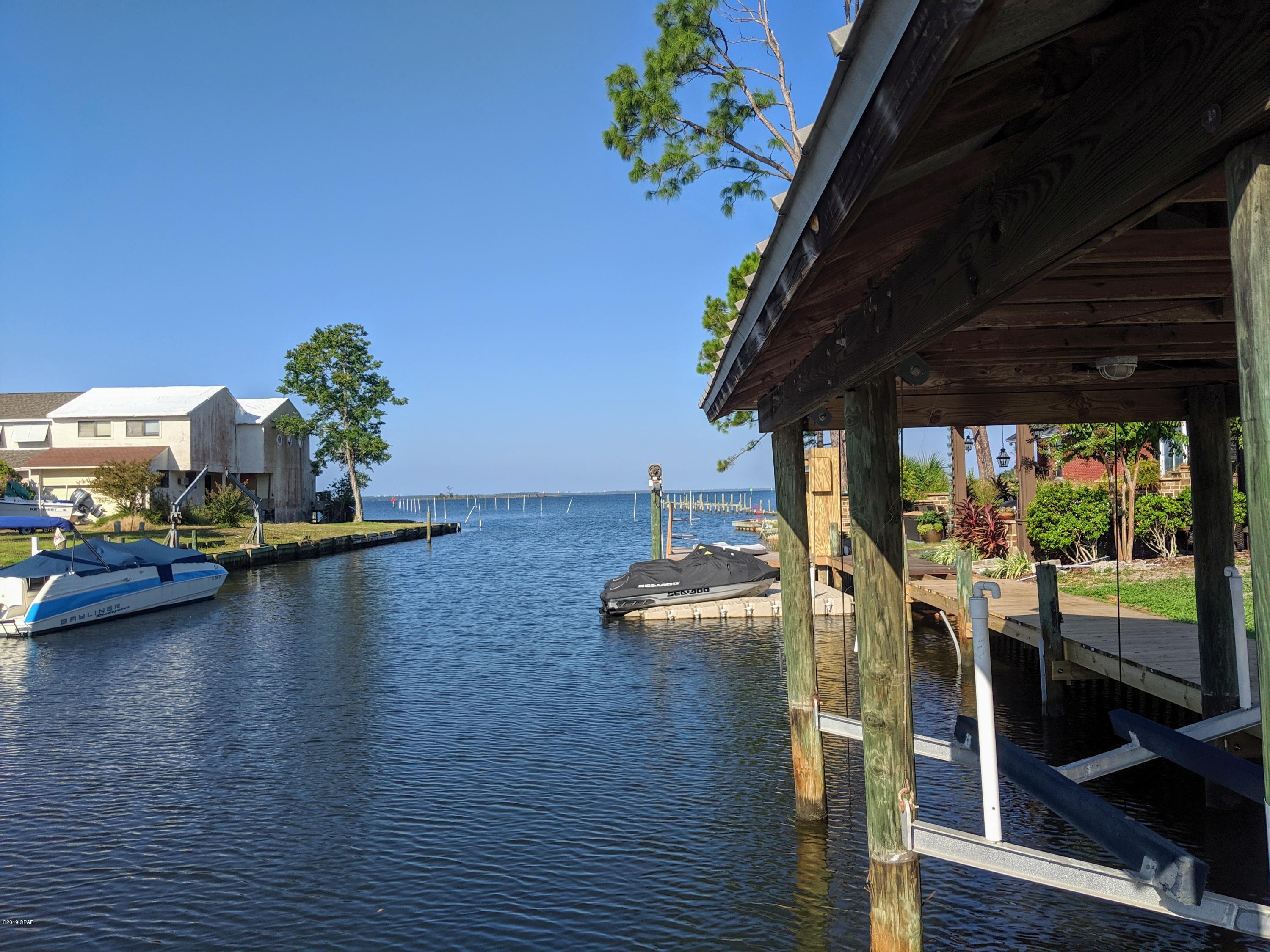 Waterfront canal lot just SECONDS from the bay. Deep water lot already has seawall. dock, boat lift, generator and well. All that is waiting is for you to build your dream home!  Beautiful Oaks that survived the storm are on the street side of the lot.