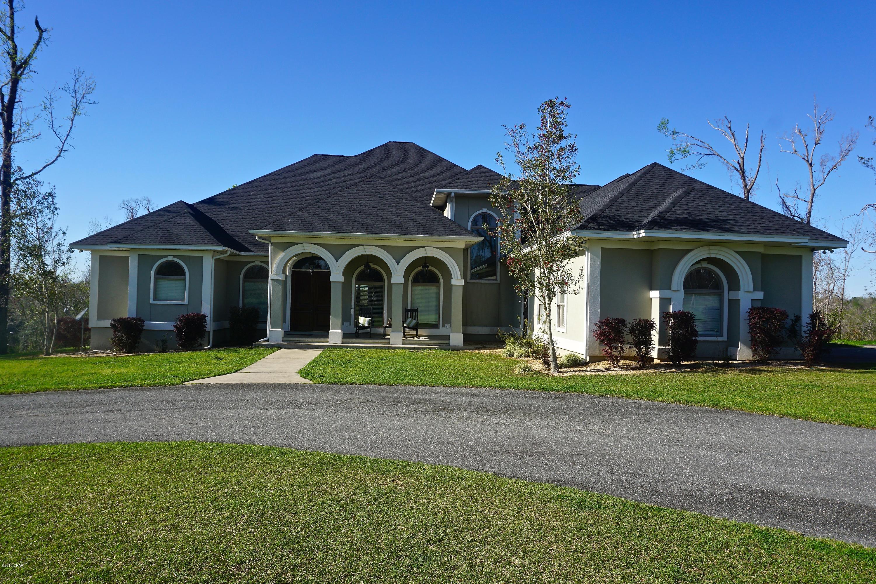 Gorgeous, executive home located in Indian Springs subdivision with 5.37+/- acres on beautiful Merritts Millpond. This home is one of a kind! It showcases cathedral ceilings in the living room w/ huge central fireplace, Brazilian hardwood floors, custom columns flanking the dining area, stunning detailed ceiling, built in safe in hallway to the garage, & split bedroom plan. This home could have 2 master suites; each with private baths & spacious walk in closets; 2 other bedrooms w/ jack and jill bath are generous sized! And an additional media room. You'll love the custom eat-in kitchen w/ windows overlooking the nearly 60 ft long backporch and saltwater, gunite swimming pool. Built for entertaining & waterfront living. Access the stunning waters of Merritts Millpond from your private dock