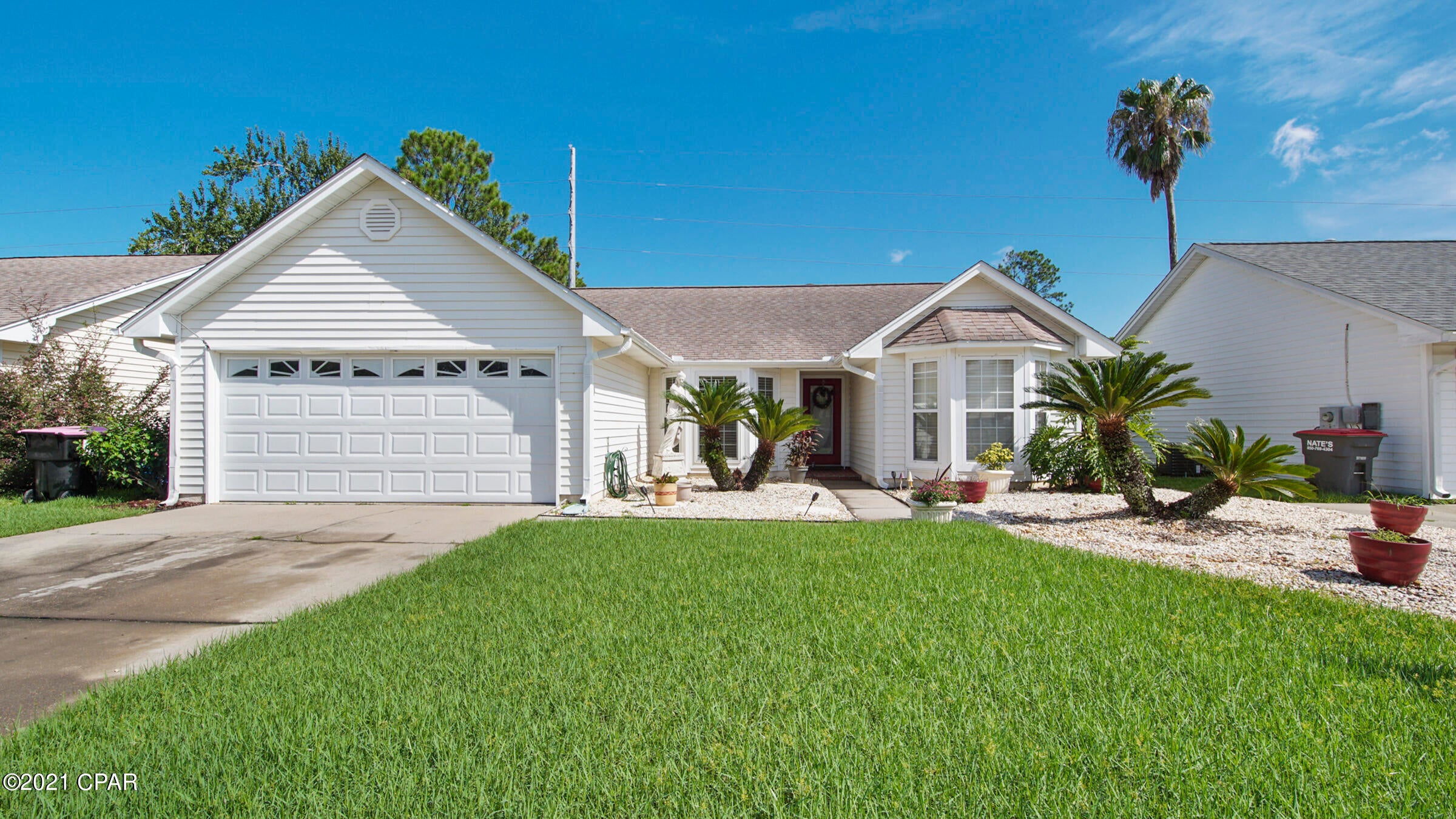 Beautiful well maintained 3/2 home only minutes to sugar white sands of the Gulf of Mexico! Lush landscaping gives great curb appeal inviting you into this home, Open floor plan featuring a great room with fireplace and vaulted ceiling, formal dining with a bay window, fully equipped kitchen with plenty of custom cabinets and breakfast area leading to a covered patio.  Master suite and bath provides a spacious walk in closet and laundry room, shower upgraded with handy cap features. leads to the sunroom.  Two additional bedrooms with bay windows and a full guest bath. Custom window treatments throughout convey. 24x12 Sunroom/entertainment with a bar area leads to the screen enclosed pool.  Fenced backyard.  A lot of space and so close to the beach, Navy Base, Pier Park , amusement themes, medical clinics and the great restaurants. Perfect location!