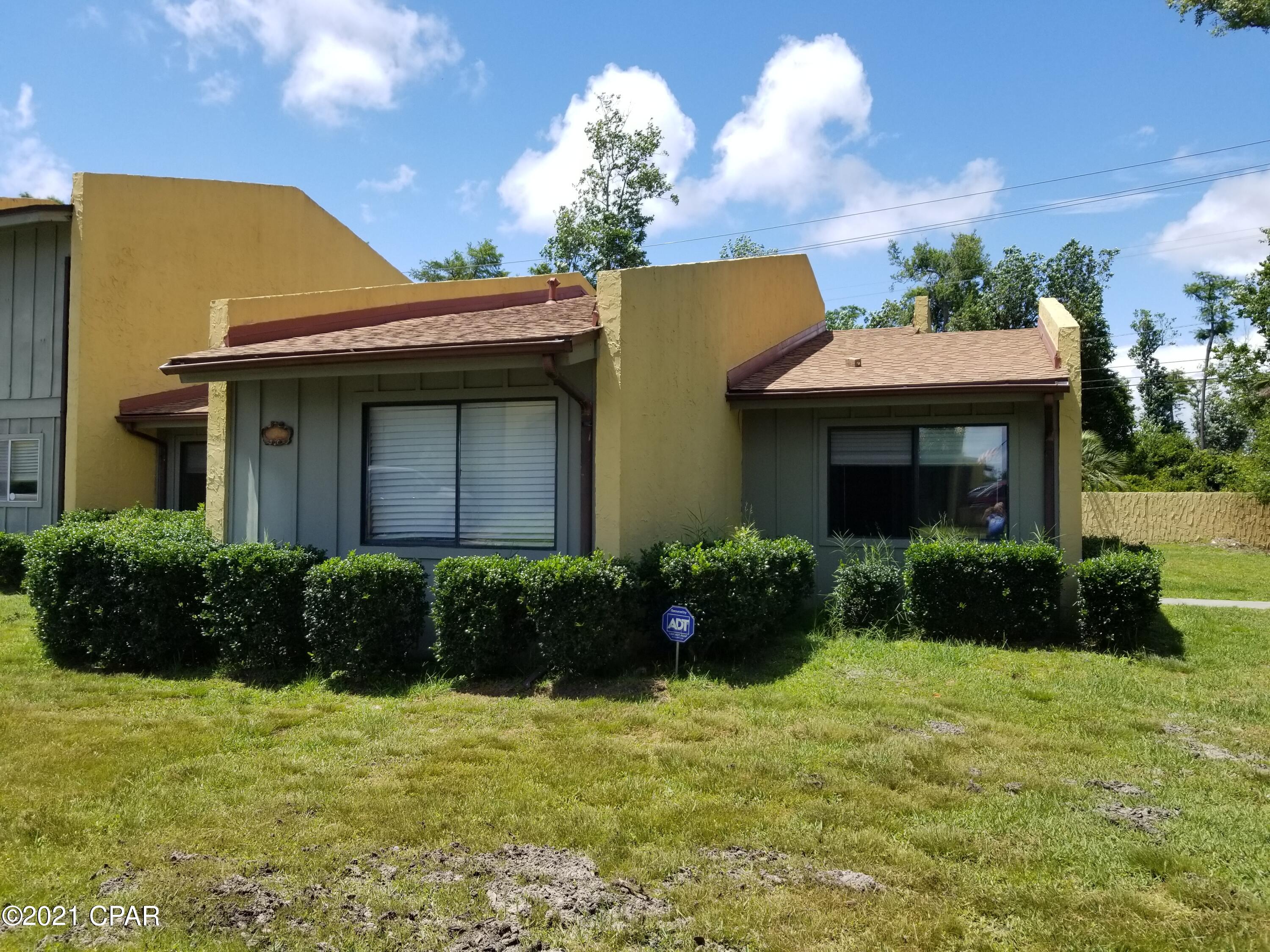 'CURRENTLY UNDER CONTRACT, SELLER ACCEPTING BACKUP OFFERS This 3 bedroom, 2 bathroom unit is part of Delwood Estates, just off 19th Street and is near the hospital, shopping, churches and restaurants. Some of the units have steps but this one has none. Mostly on tile floors, the rest is vinyl plank flooring. The kitchen is white, upper cabinets and lowers. There is also a breakfast bar and a dining area. Part of the patio has brick pavers and part of the yard is fenced for young children and pets. The unit is on the end and provides for a little more privacy, and woods is to the east side of the home. The HOA provides lawn maintenance, swimming pool maintenance along with the tennis court. A mortgage company would require flood insurance.