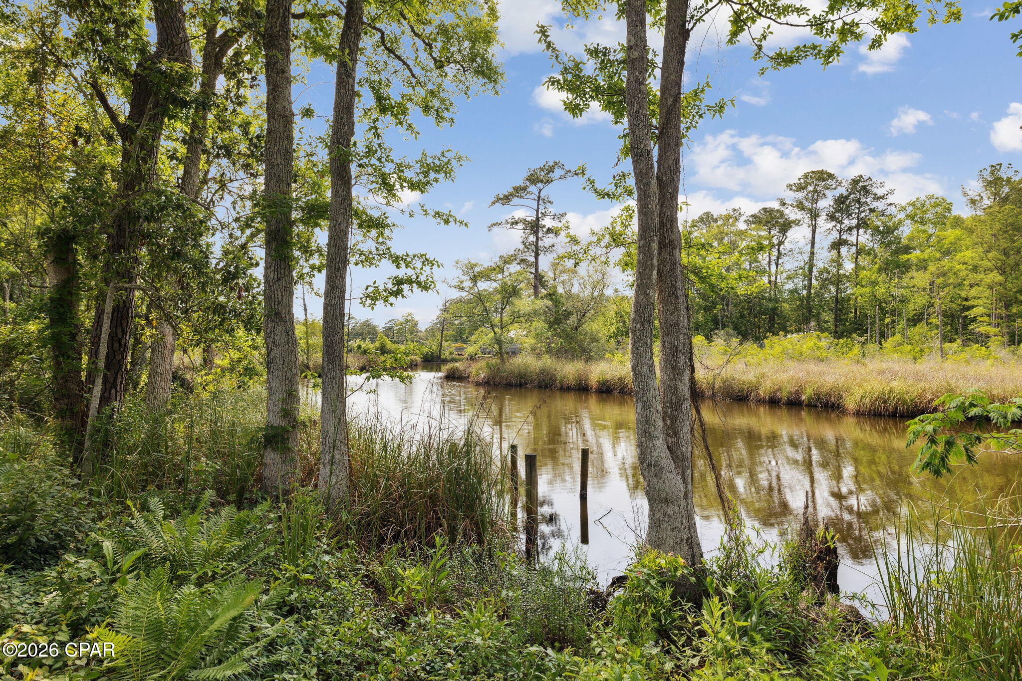 Positioned between two additional waterfront parcels, this versatile homesite offers a unique opportunity for residential, investment or assemblage potential. This approximately .44-acre parcel offers approximately 90 feet of waterfront and flexible RC - Residential/Neighborhood Commercial zoning, creating options for a private waterfront homesite, builder project, investment property or neighborhood-scale commercial use, subject to applicable approvals.
This is Lot 2 of the former 193 Ramsey Branch Road parent parcel and is positioned between two additional waterfront parcels that are also available for purchase. The property offers a unique combination of waterfront living and convenient access to the US 331 corridor, Choctawhatchee Bay and the beaches, dining and amenities of South Walton.
Boating access adds another dimension to the property, with approximately 3-5 feet of water depth and navigable access beneath the US 331 bridge, which has approximately 7 feet of vertical clearance. A boat dock may be constructed subject to applicable permitting and approvals.
For builders, developers and investors, Lot 2 presents an especially compelling opportunity because adjoining parcels are available on both sides. Lot 1 contains approximately .76 acres, approximately 262 feet of waterfront and an old boat ramp along its western end, while Lot 3 contains approximately .57 acres and approximately 111 feet of waterfront.
Together, the three parcels may be assembled into approximately 1.77 acres with approximately 463 feet of combined waterfront. With RC zoning across the entire assemblage, the combined property may accommodate a broader residential or neighborhood-commercial vision, potentially including a waterfront dining concept, hospitality use or other water-oriented development, subject to all applicable zoning, land-use, access, parking, utility, environmental and governmental approvals.
Purchase Lot 2 independently or combine it with one or both adjoining parcels to create a larger waterfront property with substantial flexibility and frontage.