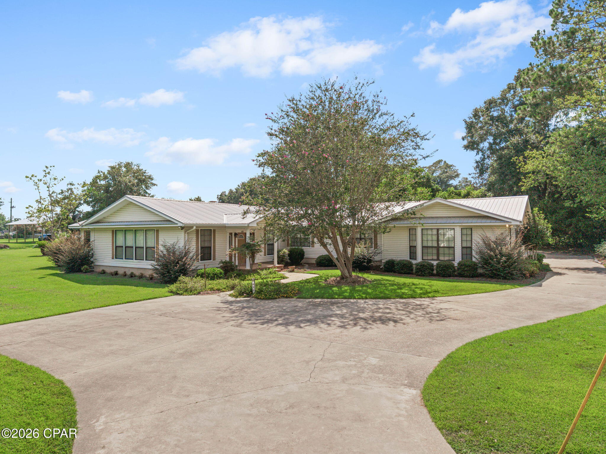 Space, versatility, and an incredible outdoor setup come together in this impressive home! Offering approximately 3,700+ square feet of living space, this home provides an abundance of room with a layout that easily adapts to everyday living, entertaining, working from home, and more. Tucked away at the quiet end of a dead-end street, the home enjoys a peaceful setting away from through traffic.Inside, multiple living areas give everyone room to spread out without sacrificing the spaces that bring people together. The inviting family room is filled with character, featuring a stone fireplace and wood beams that create a warm focal point for the space. Just steps away, the kitchen offers abundant white cabinetry, generous counter space and stainless steel appliances, with the dining area conveniently located nearby. An oversized separate living room adds even more flexibility and is perfect for creating an additional gathering, entertaining, or relaxation space. Need a dedicated space beyond the traditional bedrooms? The approximately 15' x 15' office with built-ins is a standout feature. Its size makes it equally well suited for a home office, homeschool room, playroom, craft room, library, or study area, allowing the home to easily evolve with your needs. The primary suite provides a comfortable place to unwind with a oversized walk-in closet and private bath featuring a double vanity, separate shower, and jetted soaking tub. An additional bedroom includes its own private ensuite bath, offering a wonderful setup for guests, extended family, or anyone who appreciates added privacy. The outdoor living space may quickly become a favorite part of the home. A large covered patio opens to the screened pool enclosure, creating a seamless transition from indoor to outdoor entertaining. The in-ground swimming pool is surrounded by an expansive deck with plenty of room for lounge seating, dining, and gathering with friends and family, while a conveniently located pool bath makes days spent outside even easier. Additional features include an attached two-car garage, circular driveway, dedicated laundry room, generous storage, and mature landscaping. This home offers a combination of space, functionality, and versatility that is difficult to find in Chipley. If room to live, gather, entertain, and make a home truly your own is what you've been searching for, this one is ready to impress.