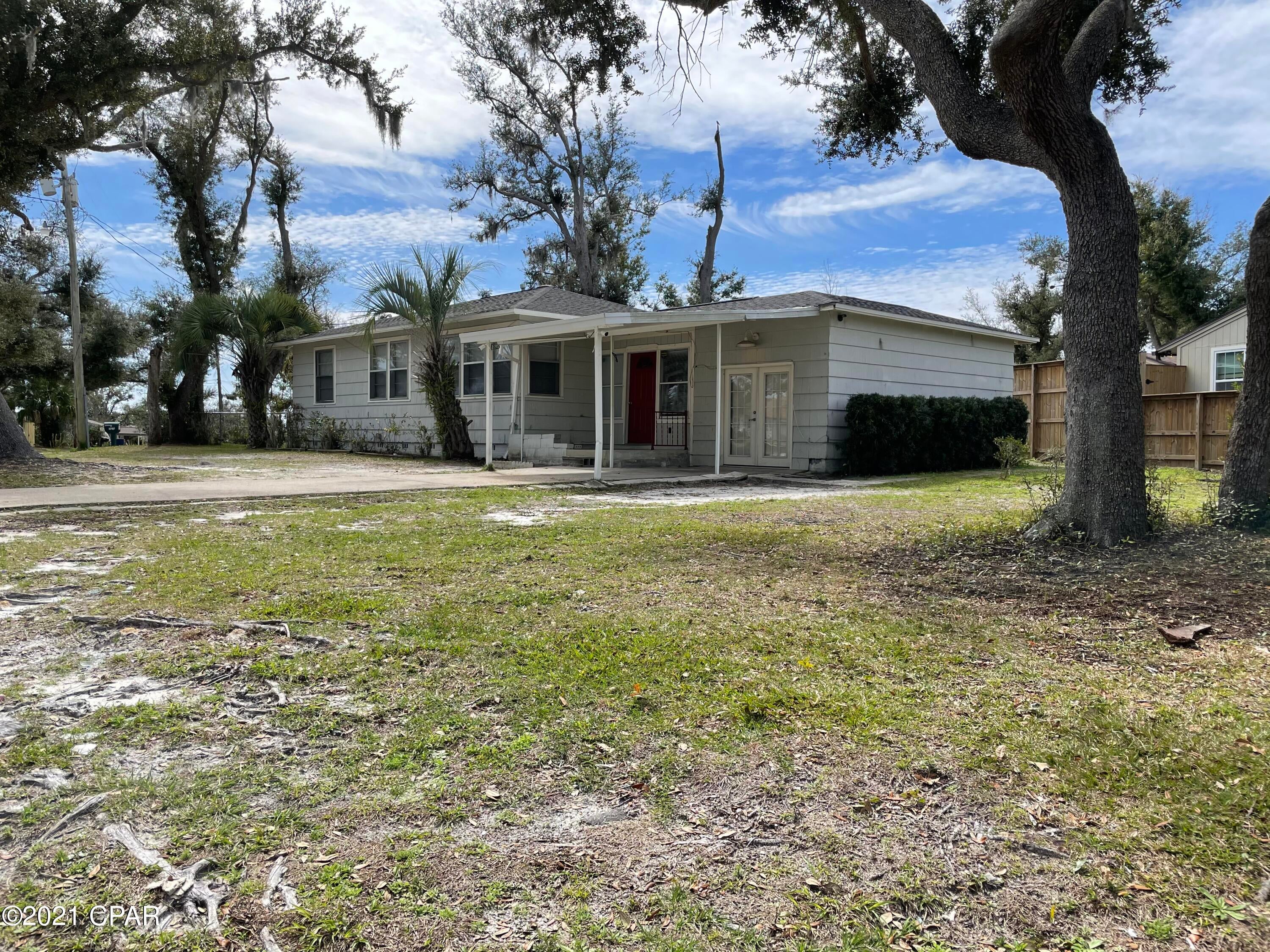 CURRENTLY UNDER CONTRACT, SELLER ACCEPTING BACKUP OFFERS Move in ready Florida Cottage located in the beautiful historic Cove Area of Panama City. Enjoy your morning coffee sitting on your covered front porch with a view of Watson Bayou. Home is close to Bay Medical Center, Tyndall AFB, downtown, restaurants, parks, shopping and of course water activities. Beautiful hardwood floors and freshly painted interior with neutral colors will match any furniture décor. Pet friendly with completely fenced in back yard and sunroom. Covered carport and front porch keeps you dry on those rainy Florida days. Large bonus room that can be entered from the tile foyer or French doors cover by the carport.  Large lot has plenty of space to park your boat or RV.  Greet your neighbors as you enjoy cool evenin Bayou. Covered back porch is a perfect spot for BBQ's and outside dining. All measures are approximant and should be verified if important. Call your favorite Realtor to see this cute cottage in the Cove today.