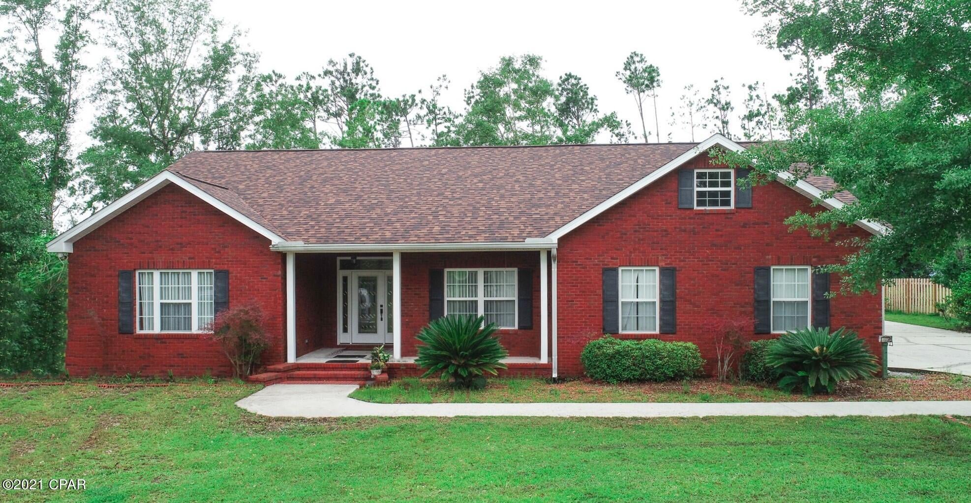 Looking for your piece of paradise with a little elbow room. This custom-built all brick 3 bedrooms 2 bath home is situated on 1.14 acres, 15 minutes to Panama City, 35 minutes to Tyndall AFB. Home features all brick siding with vinyl trim, tile through the family room, and all wear areas. Carpet in the bedroom and dining. Custom kitchen cabinets, all-black appliances, and a walk-in pantry. All large bedrooms with oversized closets, the master suite has room for a king-size bed, walk-in closet, master bath offers dual vanities, large tub, and separate walk-in shower. The home also features crown moldings, 6'' baseboards, ceiling fans in all rooms. Exterior features a large screened-in porch, oversized parking area, 20 x 12 insulated workshop, and attached two-car, carport. Call today.