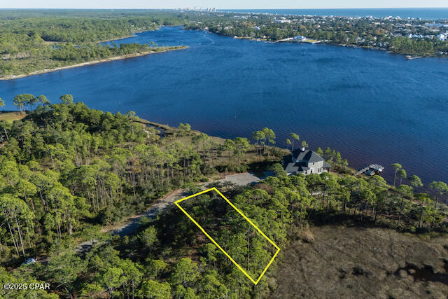 Do not miss out on this premium homesite in the Wild Heron community, ideal for those seeking a serene and luxurious lakeside lifestyle. This beautiful homesite will have front, back and south side views of Lake Powell, Florida's largest coastal dune lake. This lot offers privacy under majestic old oaks and captivating water views. Wild Heron boasts a coastal craftsman charm and is home to the renowned Greg Norman's Shark's Tooth Golf Course, with a future course designed by Davis Love III on the way. A Watersound Club membership is necessary to access these elite golf amenities, making this property perfect for golf enthusiasts and nature lovers alike.

Wild Heron provides an exceptional living experience with world-class amenities, including 24-hour security, a gated entrance, a lakeside grill and fire pit, a community swimming pool, fitness center, and nature trails. The Wild Heron community is conveniently located on the west end of Panama City Beach, which is just minutes from Pier Park and the renowned 30A area. Offering a tranquil, family-friendly atmosphere, Wild Heron prohibits short-term rentals, ensuring a peaceful and private environment for its residents.