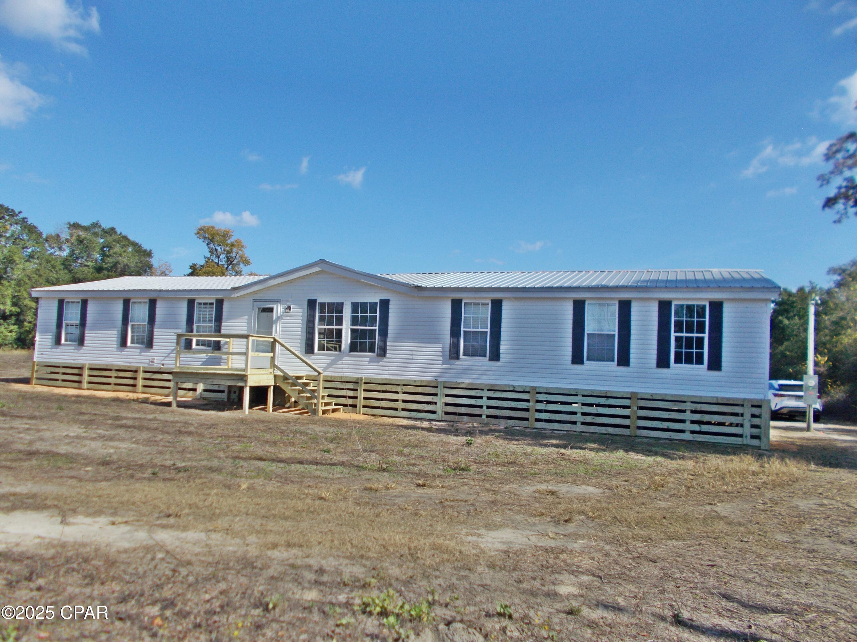 Double wide mobile home on 1 ac the home has been updated with new flooring, new paint, new well, new septic, new power pole, The kitchen is large and open with a island bar,  the master bedroom is very large with a office/nursery joining it, the master bath is large with garden tub and separate shower double vanity and large walk in closet. There is a large family room to enjoy, this home is ready to move into. it is a very large home and has a metal roof.