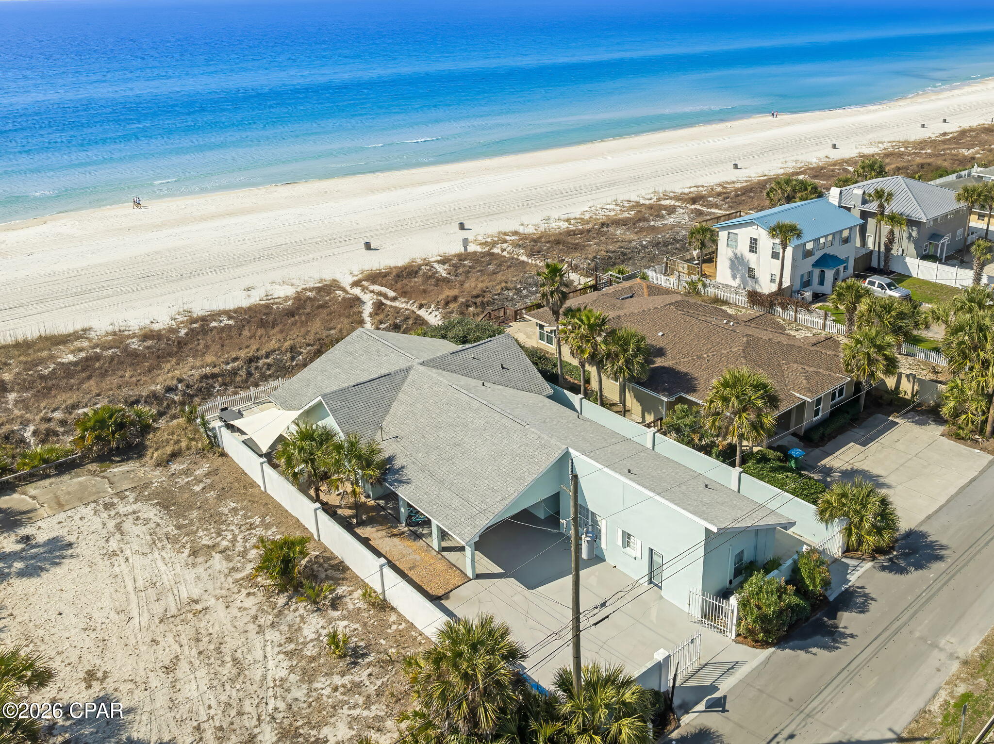 Oceanfront Gulf-front 4BR/4BA + flex room home with proven rental history and exceptional versatility. Offering over a decade of consistent VRBO performance, this property presents a strong income-producing opportunity with additional upside potential. Designed for both comfort and functionality, the layout includes a 2BR/2BA main residence plus two private guest suites with full baths connected by a breezeway, ideal for multi-generational living or maximizing rental occupancy.

Enjoy panoramic Gulf views from the sunroom and main living areas, complemented by an open-concept layout perfect for entertaining. The home features an updated kitchen, remodeled primary bath, and is being sold fully furnished for a true turnkey experience. Outdoor living includes a spacious back porch, jacuzzi, BBQ area, and direct beach access, creating an ideal setting for both personal use and guest enjoyment.

Recent improvements include roof, HVAC systems, and impact windows and doors, offering added durability and peace of mind. Located on a private drive with a 35-ft seawall for enhanced protection.

A rare opportunity to own a beachfront property that combines lifestyle, income, and long-term potential in Panama City Beach.
