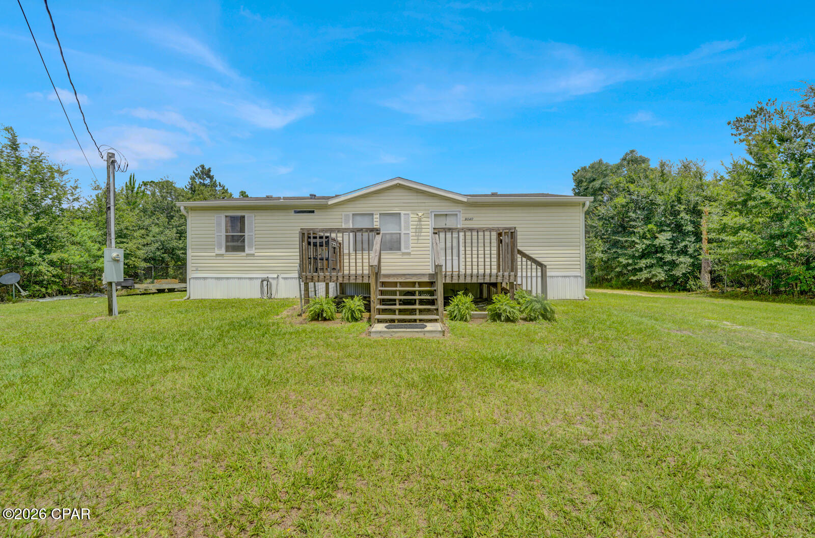 Welcome to peaceful country living in the heart of Bayou George! Nestled on approximately 0.80 acres, this charming 3-bedroom, 2-bath manufactured home offers the perfect combination of privacy, outdoor space, and everyday convenience.

Surrounded by mature trees and with wooded, undeveloped land directly behind the property, you'll enjoy a peaceful setting with added privacy and no rear neighbors. Whether you're sipping your morning coffee on the front porch, relaxing after a long day on the back porch, or simply enjoying the sounds of nature, this property offers the quiet lifestyle you've been searching for.

The spacious lot provides plenty of room for children and pets to play, gardening, entertaining, or simply spreading out and enjoying your own piece of the outdoors. A large detached storage shed provides abundant space for lawn equipment, tools, outdoor toys, hobbies, or additional storage.

Inside, the home features a functional layout with three bedrooms and two full bathrooms, offering comfortable living for first-time homebuyers, growing families, downsizers, or anyone looking for affordable living with room to breathe.

Located in the charming community of Bayou George, you'll enjoy the slower pace of country living while remaining conveniently close to everyday amenities. Shopping, restaurants, schools, and medical facilities are just 15 minutes away, while Tyndall Air Force Base offers an easy commute for military personnel and civilian employees alike. Spend your weekends enjoying the beautiful sugar-white sand beaches of Panama City Beach, located approximately 35 minutes away, or take advantage of the convenient drive to Naval Support Activity Panama City.

If you've been searching for a property that offers privacy, outdoor living, generous yard space, and a peaceful country atmosphere without sacrificing convenience, this home is one you won't want to miss. Come experience all that this Bayou George property has to offer and imagine yourself enjoying the best of quiet country living with easy access to everything the Florida Panhandle has to offer.