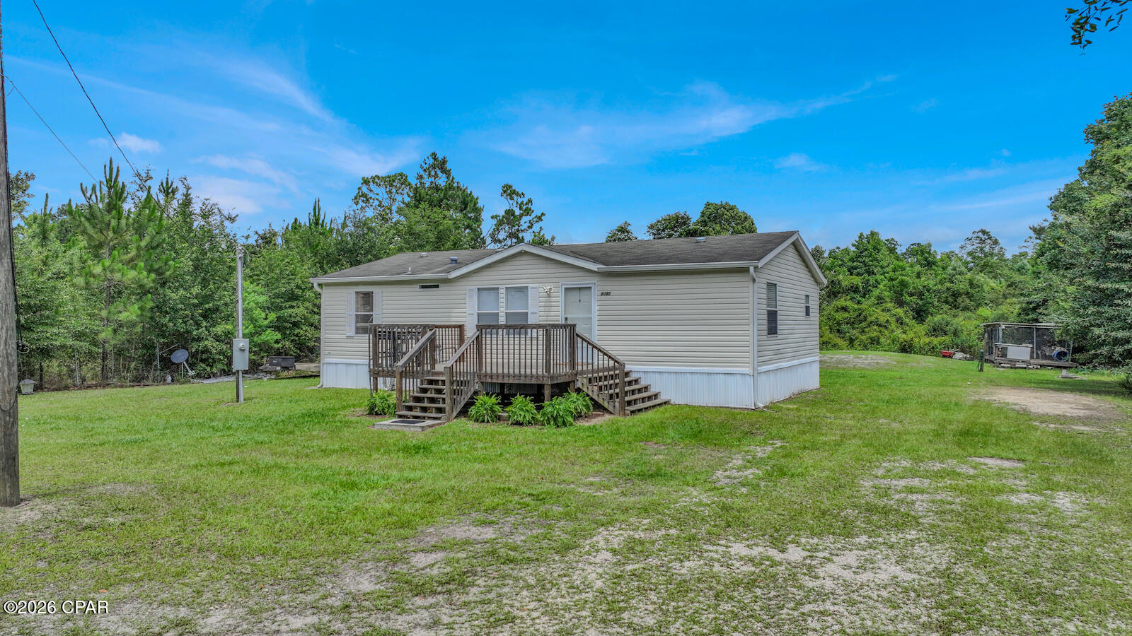 Welcome to peaceful country living in the heart of Bayou George! Nestled on approximately 0.80 acres, this charming 3-bedroom, 2-bath manufactured home offers the perfect combination of privacy, outdoor space, and everyday convenience.

Surrounded by mature trees and with wooded, undeveloped land directly behind the property, you'll enjoy a peaceful setting with added privacy and no rear neighbors. Whether you're sipping your morning coffee on the front porch, relaxing after a long day on the back porch, or simply enjoying the sounds of nature, this property offers the quiet lifestyle you've been searching for.

The spacious lot provides plenty of room for children and pets to play, gardening, entertaining, or simply spreading out and enjoying your own piece of the outdoors. A large detached storage shed provides abundant space for lawn equipment, tools, outdoor toys, hobbies, or additional storage.

Inside, the home features a functional layout with three bedrooms and two full bathrooms, offering comfortable living for first-time homebuyers, growing families, downsizers, or anyone looking for affordable living with room to breathe.

Located in the charming community of Bayou George, you'll enjoy the slower pace of country living while remaining conveniently close to everyday amenities. Shopping, restaurants, schools, and medical facilities are just 15 minutes away, while Tyndall Air Force Base offers an easy commute for military personnel and civilian employees alike. Spend your weekends enjoying the beautiful sugar-white sand beaches of Panama City Beach, located approximately 35 minutes away, or take advantage of the convenient drive to Naval Support Activity Panama City.

If you've been searching for a property that offers privacy, outdoor living, generous yard space, and a peaceful country atmosphere without sacrificing convenience, this home is one you won't want to miss. Come experience all that this Bayou George property has to offer and imagine yourself enjoying the best of quiet country living with easy access to everything the Florida Panhandle has to offer.