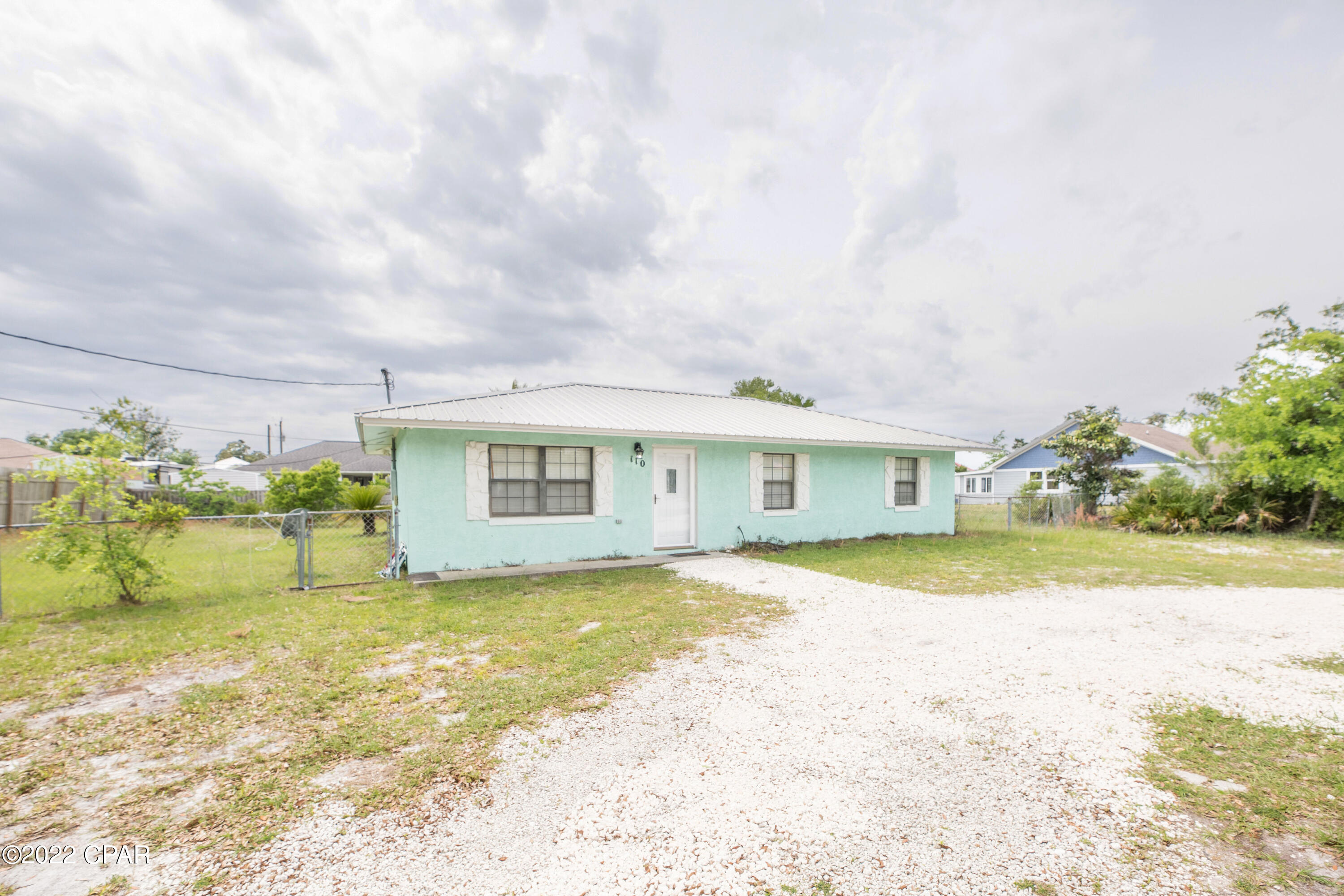 Purchasing this 3/2 home will give you a turnkey business for your next investment property. Being sold fully furnished with a strong rental history already in place. No HOA! With a third of an acre parcel, there is room for a pool, mother in-law suite, large shop/shed, or RV storage. Their is so much potential with this property as it is zoned multi family. You can live in the home and build two small homes for short term rentals. This cinder block construction home has a newer metal roof, and new HVAC in 2021. Centrally located to everything in PCB. Only 2.5 miles to Pier Park, 1.5 miles to the county pier or Shipwreck Island Water Park and less than a mile to beach access 47. Don't miss out on this turnkey business opportunity.