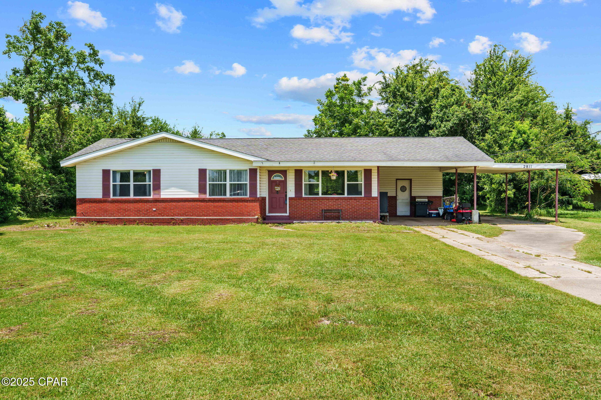Set on a generous lot with mature trees and no neighbors crowding your backyard, this home offers the kind of privacy and breathing room that's hard to find. Inside, you'll be greeted by fresh paint, updated LVP flooring, and a wide-open living and dining area perfect for gathering with family or watching the game with friends. The kitchen keeps it classic with a clean, functional layout and ample cabinet space.

You'll find three spacious bedrooms, including a large primary suite with room to unwind at the end of the day. Bonus points for the oversized covered carport and extra storage space! Bring your boat, your tools, your toys ... there's plenty of room for all of it.

Whether you're looking to plant roots or pick up a solid rental investment, 2811 E 13th is a dependable choice with room to grow. No HOA, no nonsense - just good bones and great potential. Tucked into the heart of Panama City, just a short drive from Tyndall Air Force Base, schools, shopping, and the revitalized downtown district.

Priced to sell fast! Call a Realtor & see it today!