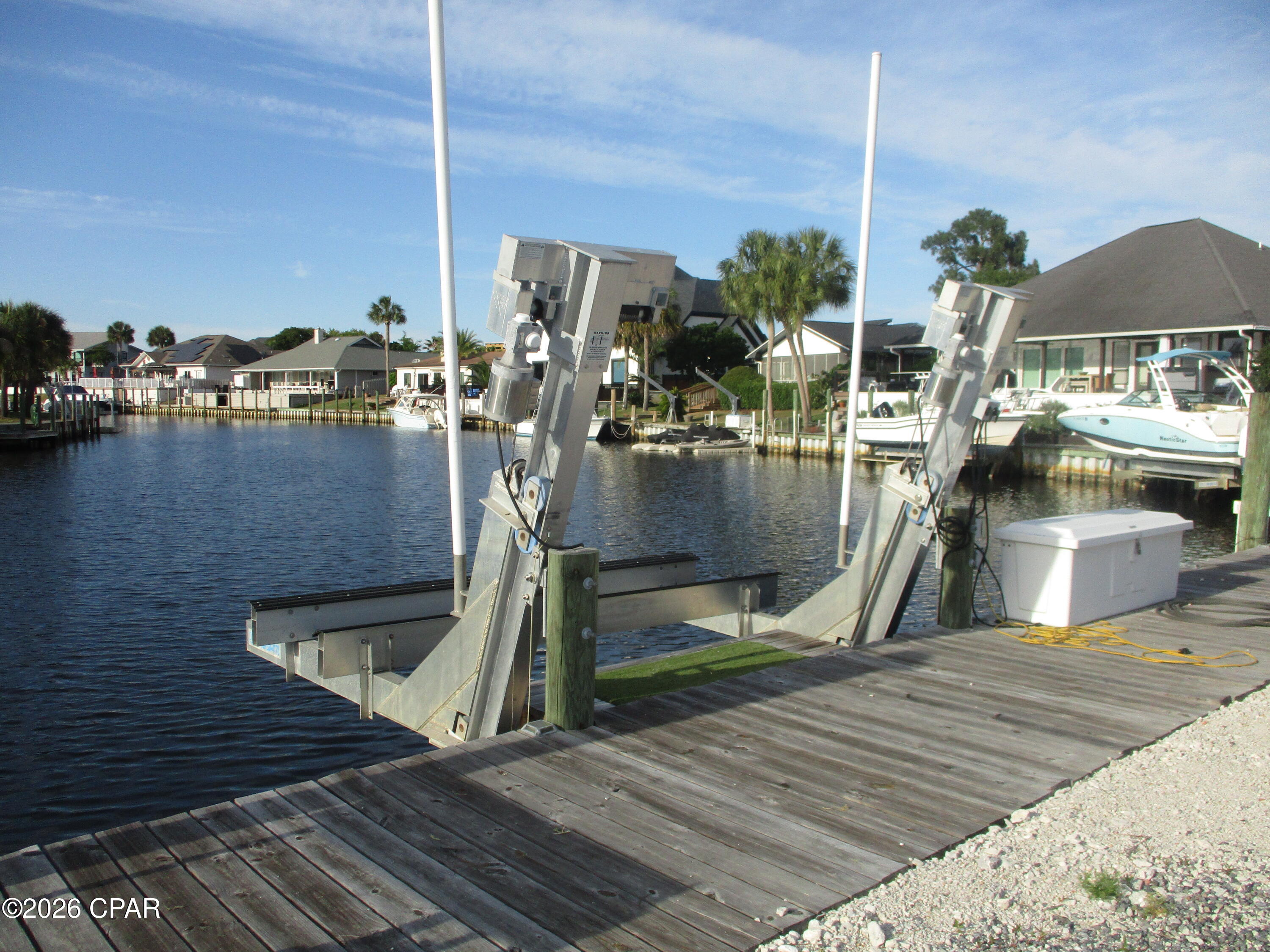 Build your dream waterfront home and keep your boat right in your backyard! This is one of the few remaining deep-water canal homesites available in the  gated community of Bay Point. Ready for construction, the property is already equipped with water, power, and a boat lift, saving valuable time and significant development costs. An added bonus is its ideal positioning, offering long, picturesque views down the canal rather than directly across, creating a more open and impressive waterfront setting. House plans are available, making it even easier to bring your vision to life. Enjoy direct deep-water access from your dock to the Gulf, whether you're heading out for a day of fishing, cruising to Shell Island, or simply enjoying life on the water. Bay Point is one of Panama City Beach's premier gated communities, featuring 24-hour security, a Jack Nicklaus championship golf course, a full-service marina, on-site dining, and beautifully maintained grounds. Conveniently located just minutes from St. Andrews State Park, Shell Island, shopping, restaurants, and the sugar-white beaches of the Gulf Coast. Rare opportunities like this don't come along often. Build exactly what you've been dreaming of in one of the area's most desirable waterfront communities. Seller is a Florida licensed real estate agent.